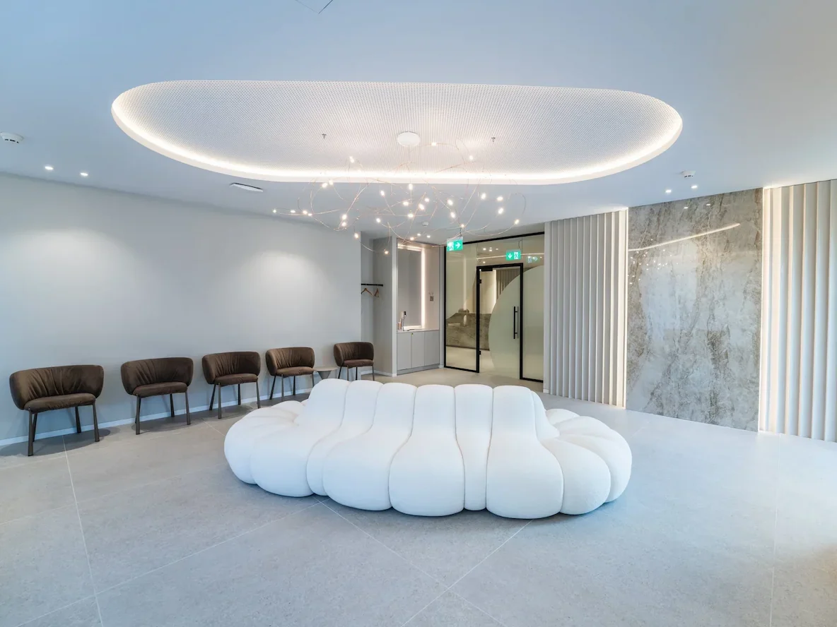 Moderner Wartebereich einer Praxis mit Lounge-Sitzmöbel, Lichtdecke und hochwertigem Praxisdesign