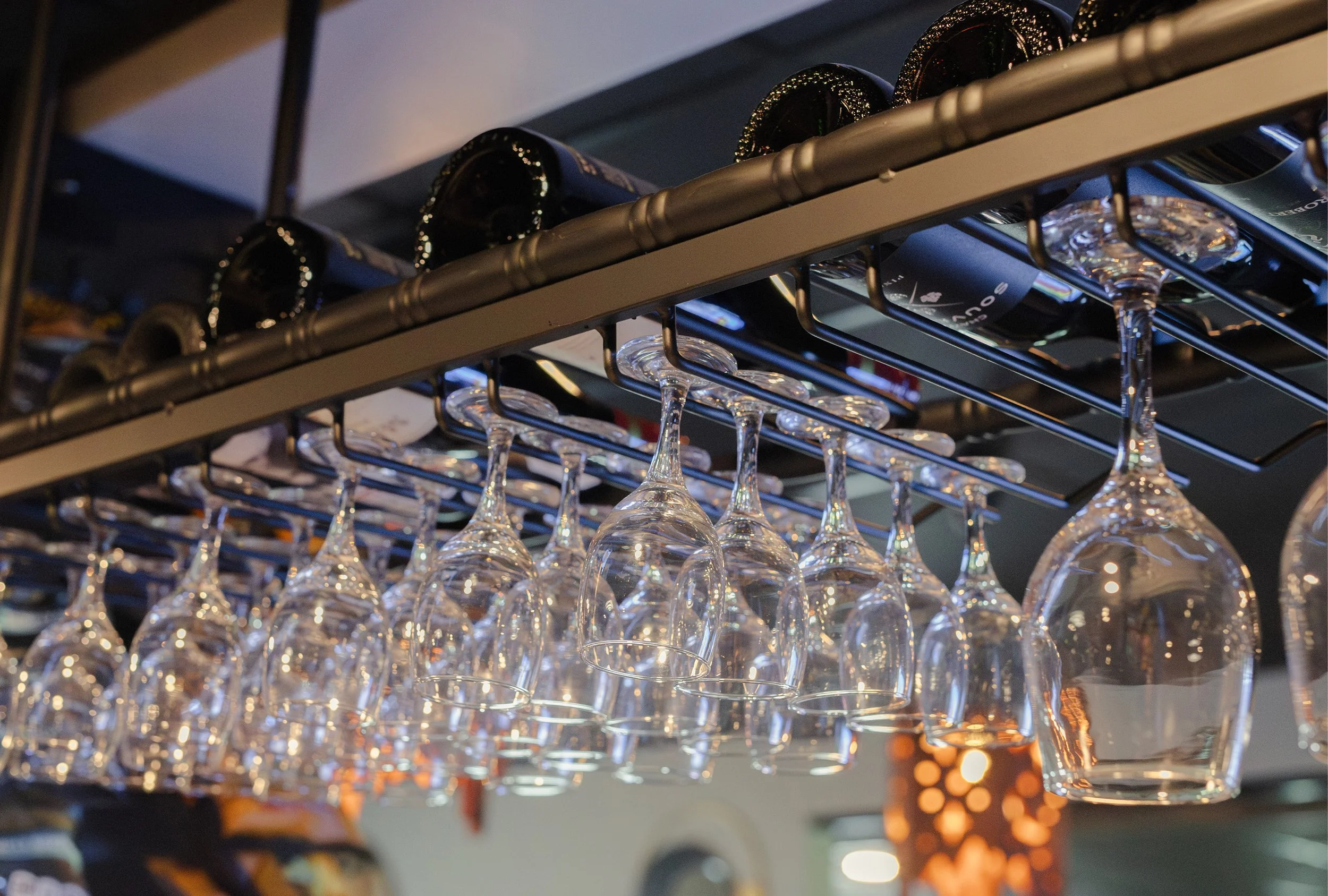 Wine glass rack above the bar