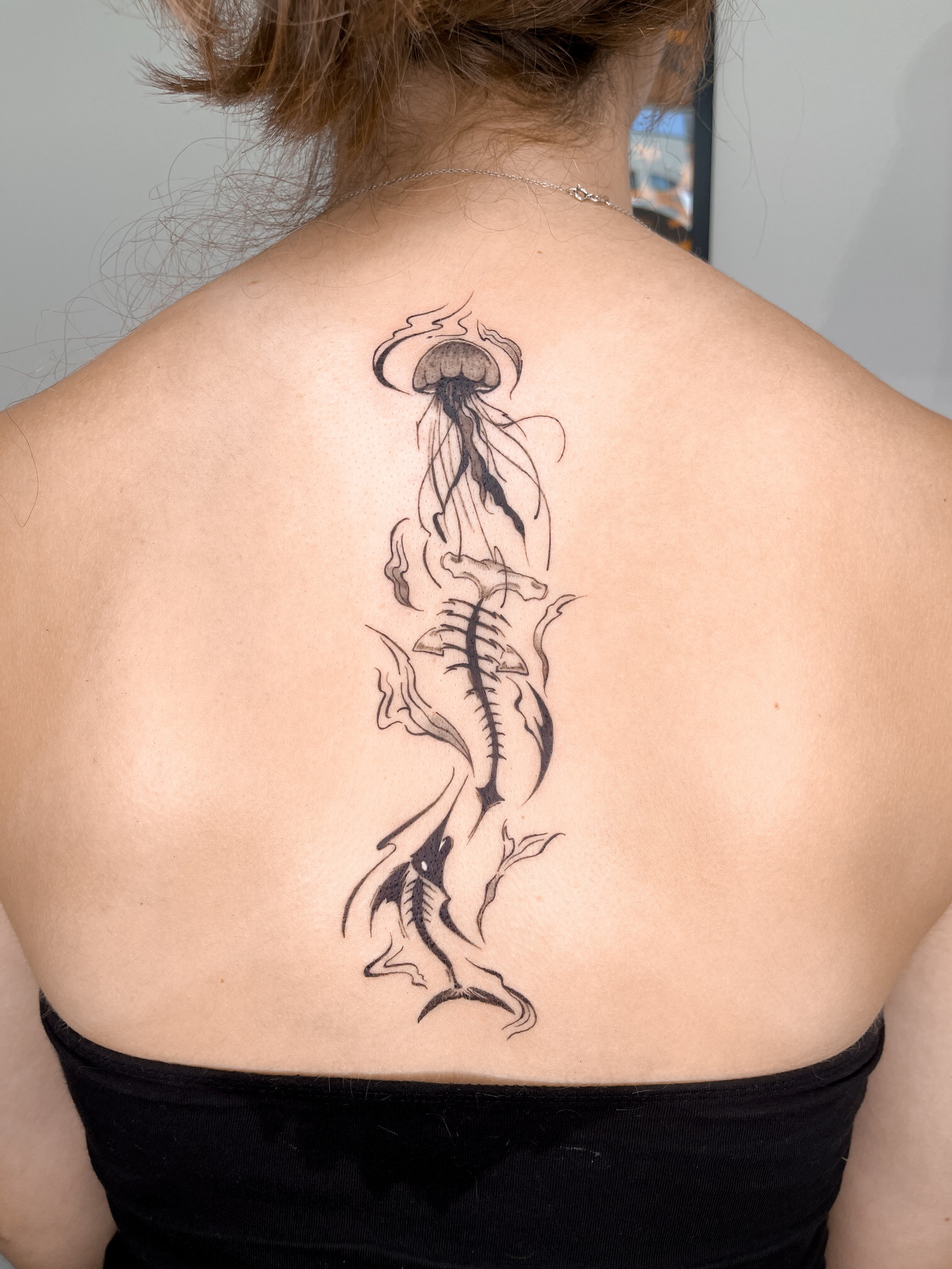 A mixture of whimsical and grungy blackwork. Client wanted skeletons of aquatic creatures, specifically sharks. Included is a skeleton of a hammerhead shark, a swordfish, and a jellyfish