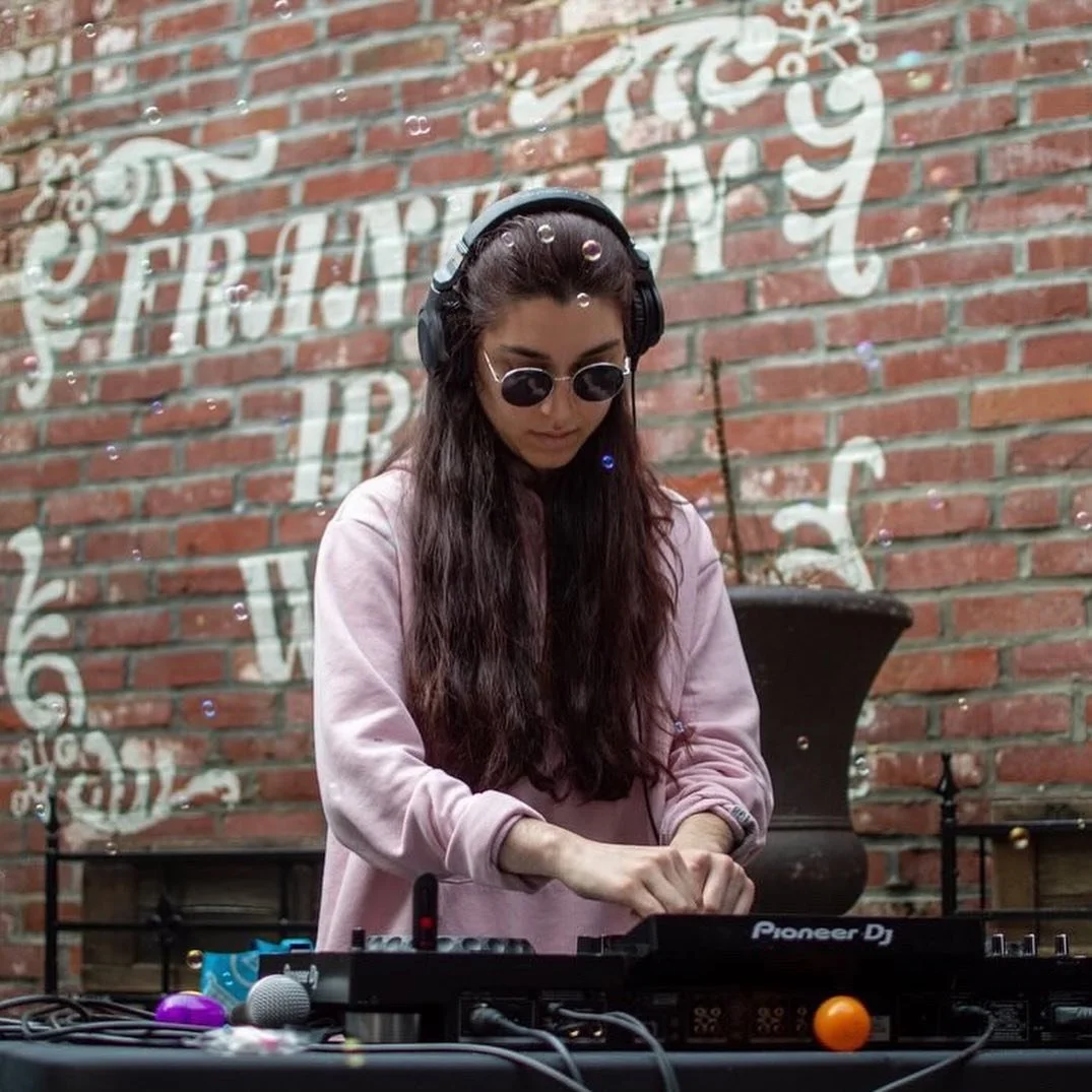 Woman performing a DJ set in Philly