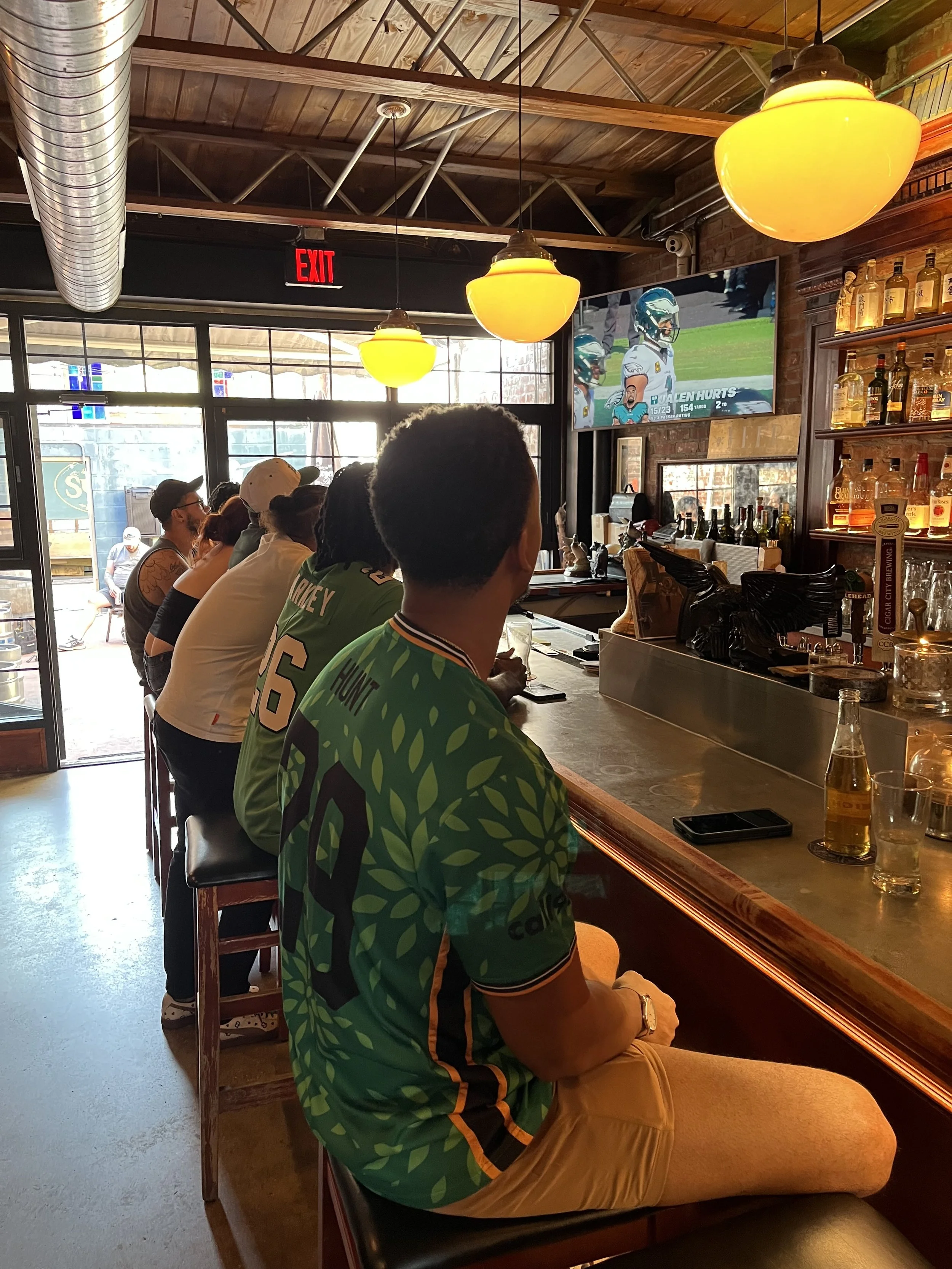Eagles fans watching a football game at Sutton's Bar