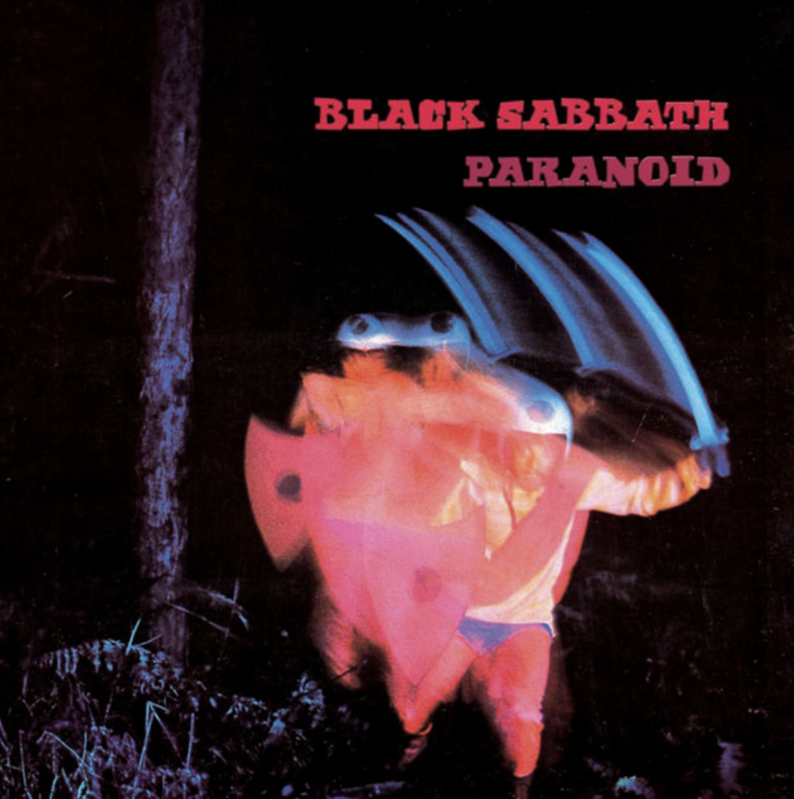 Album cover for Black Sabbath's 'Paranoid' featuring a figure in a pink-orange suit with a large blue umbrella, standing outdoors at night beside a tree.