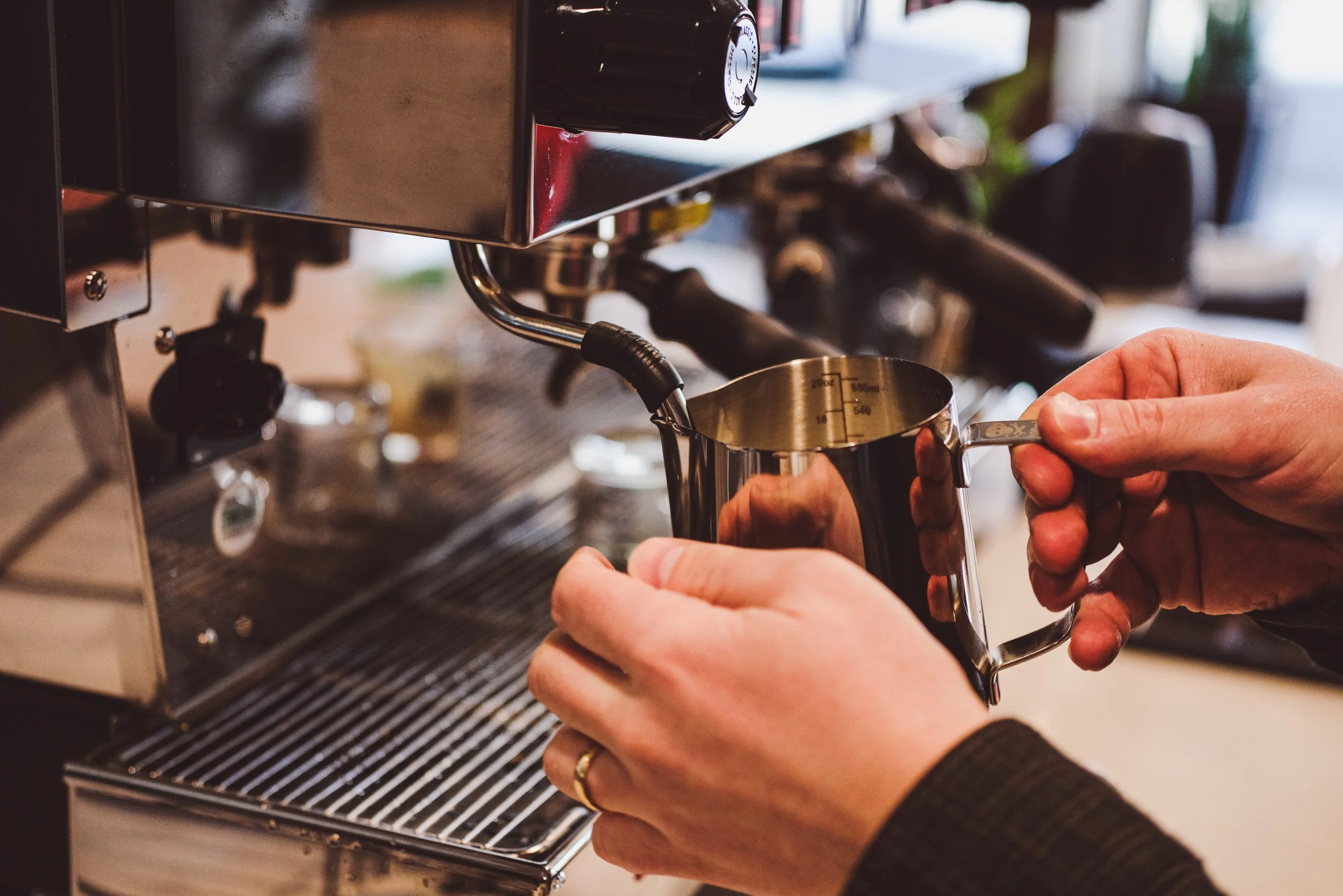 barista steaming milk for a latte