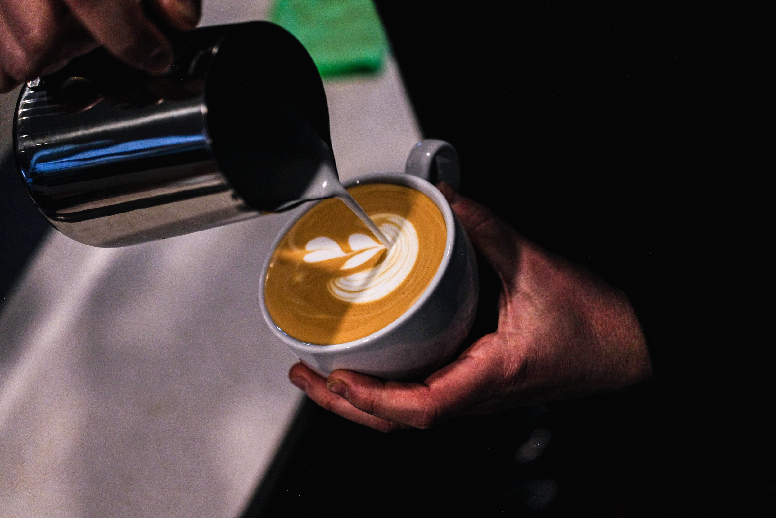 close up of 3 different coffee mugs with artistic barista image on top