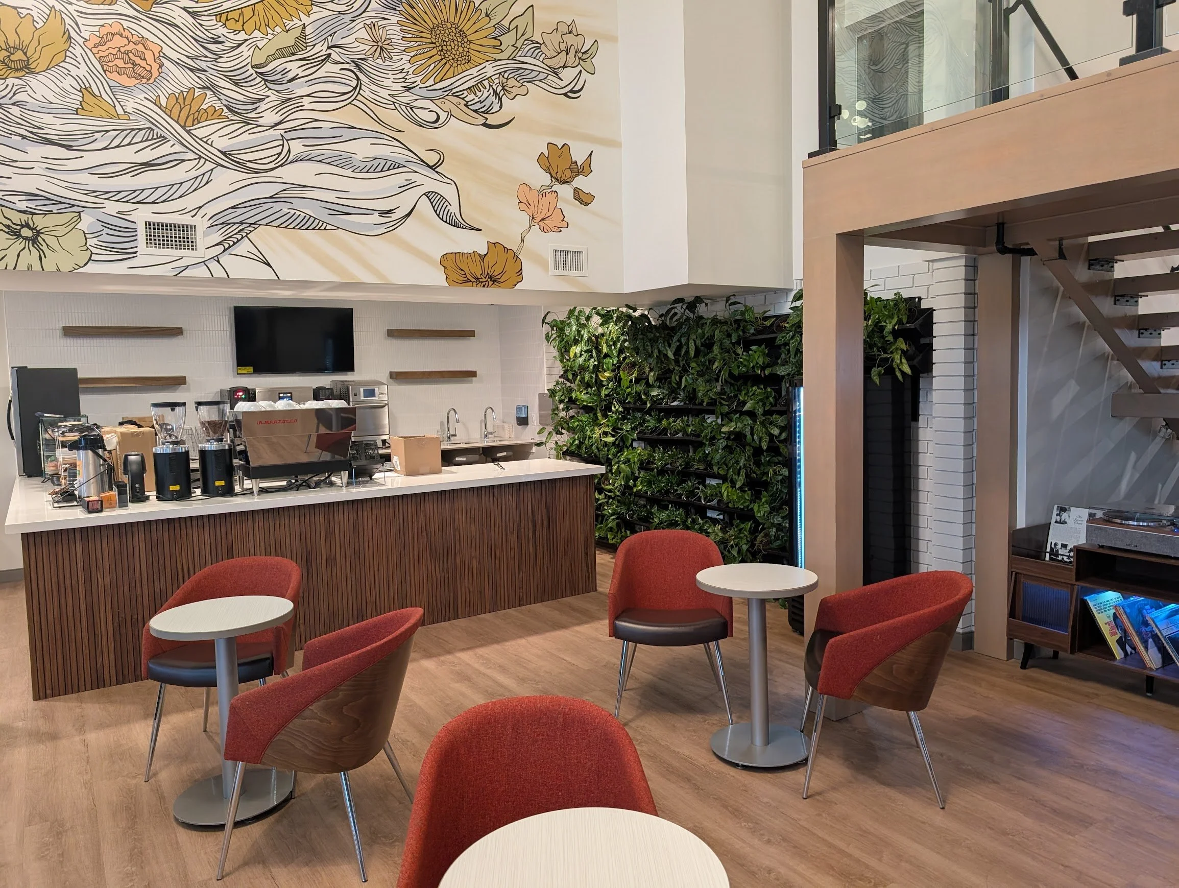 Caesura cafe with tables and chairs under the Oregon trail mural