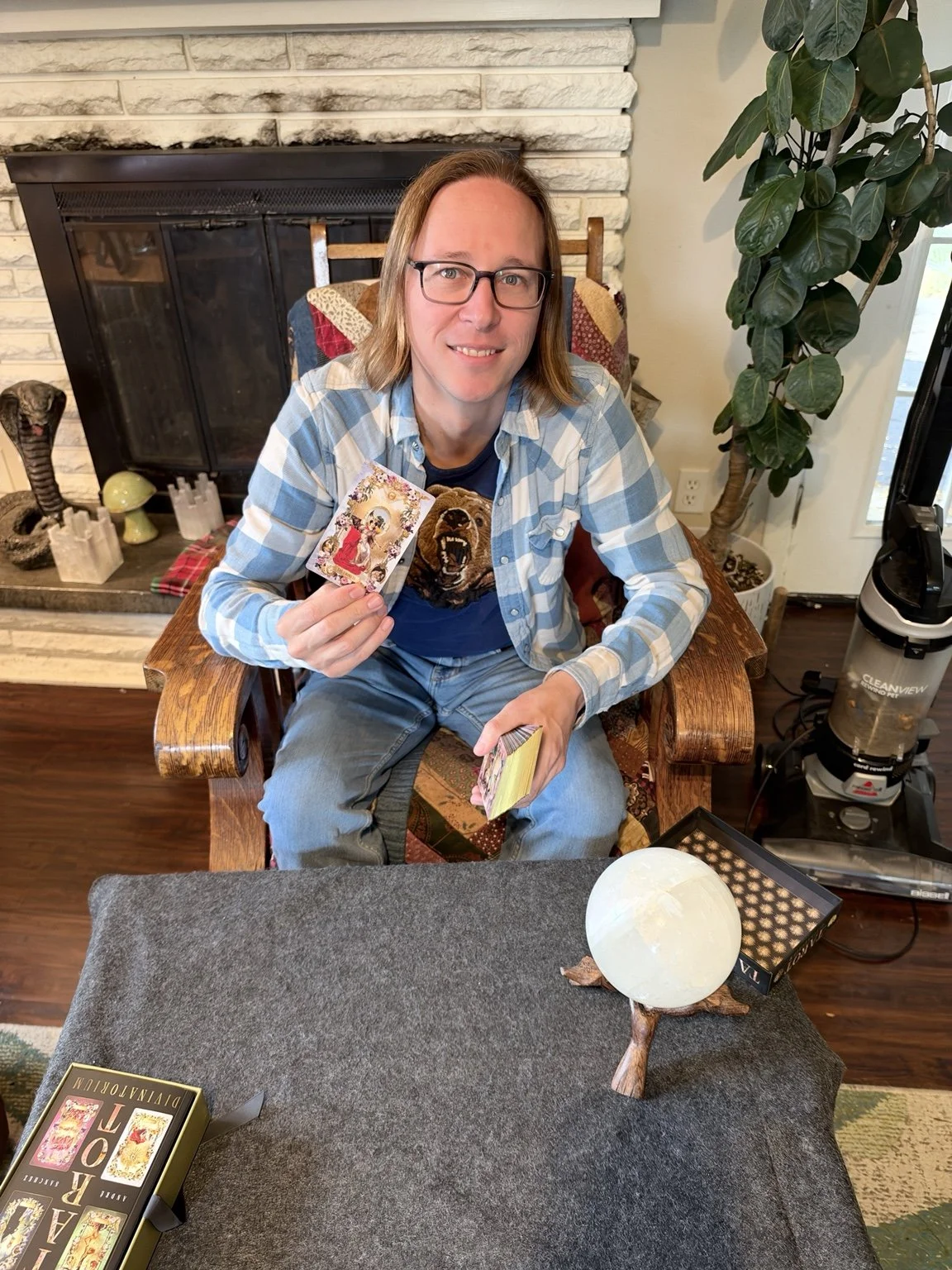 Jake Prieto seated with tarot cards and a crystal sphere.