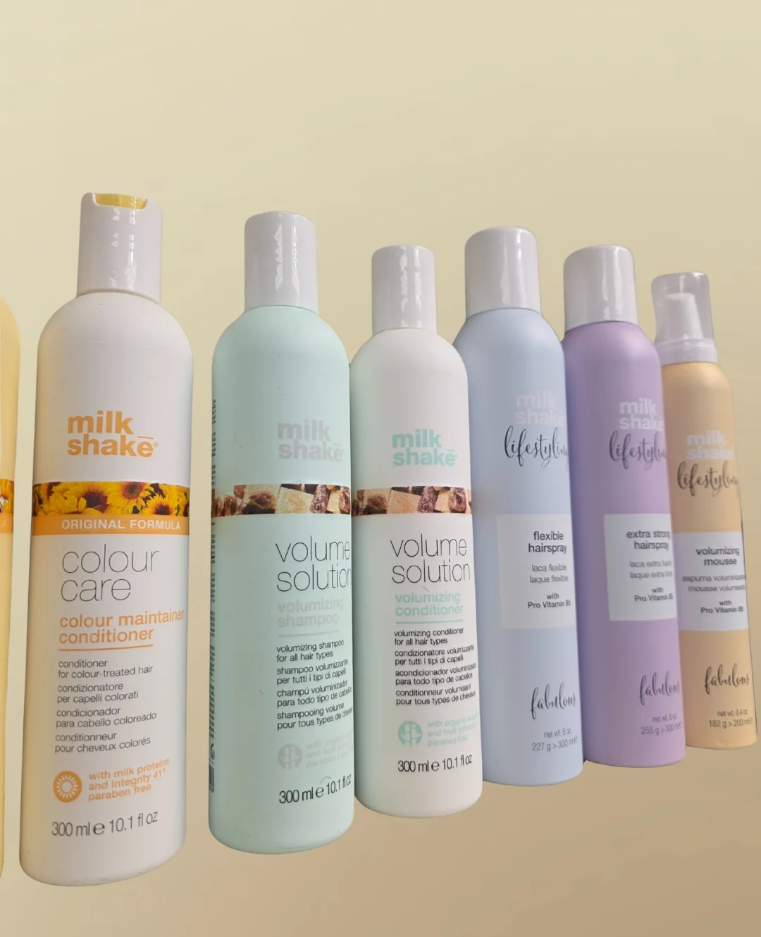 Bottles of Milk Shake shampoo, conditioner, and other hair care.