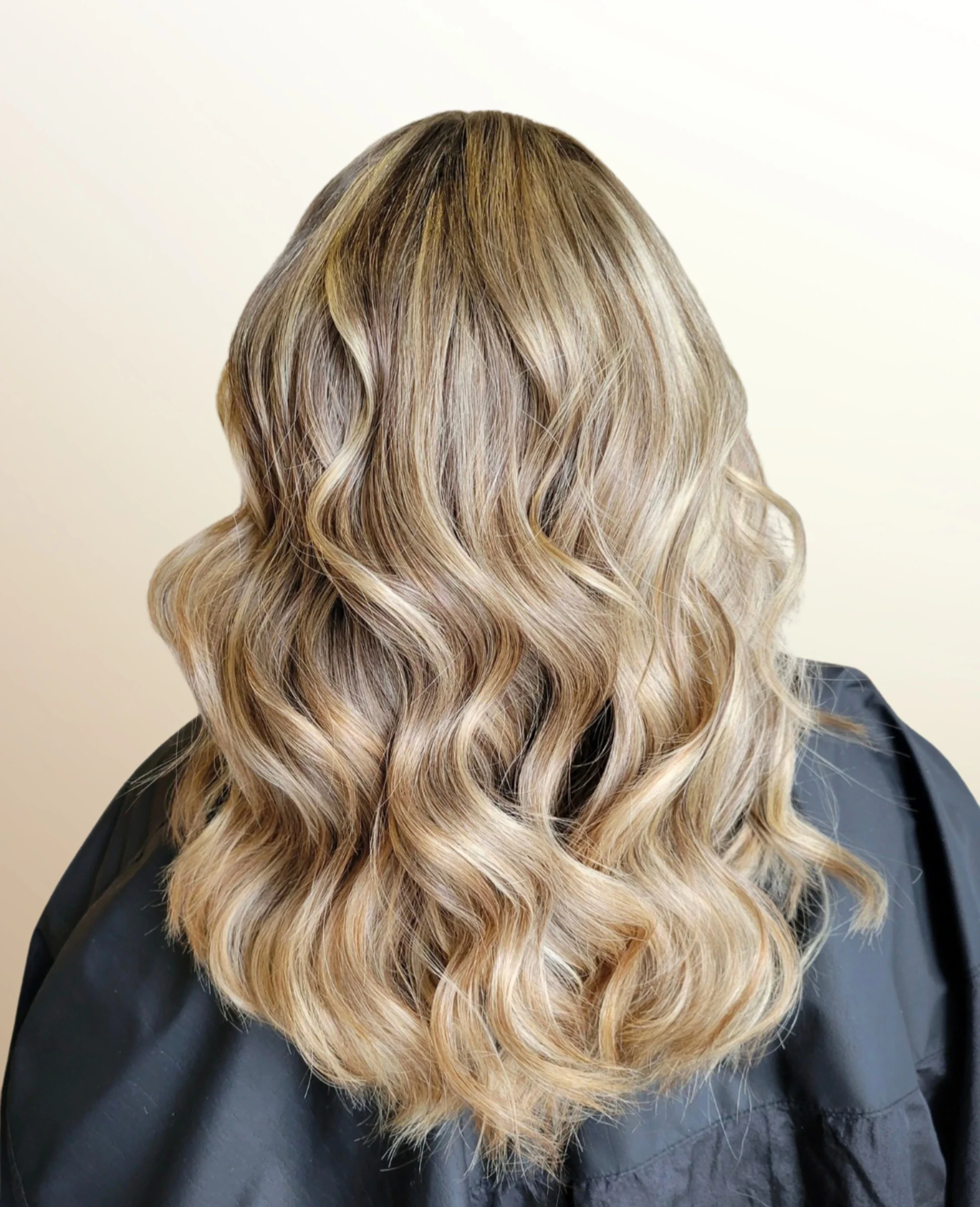 Back view of shoulder-length hair with blonde highlights at Signature Strands Hair Studio, Harrisburg, NC.