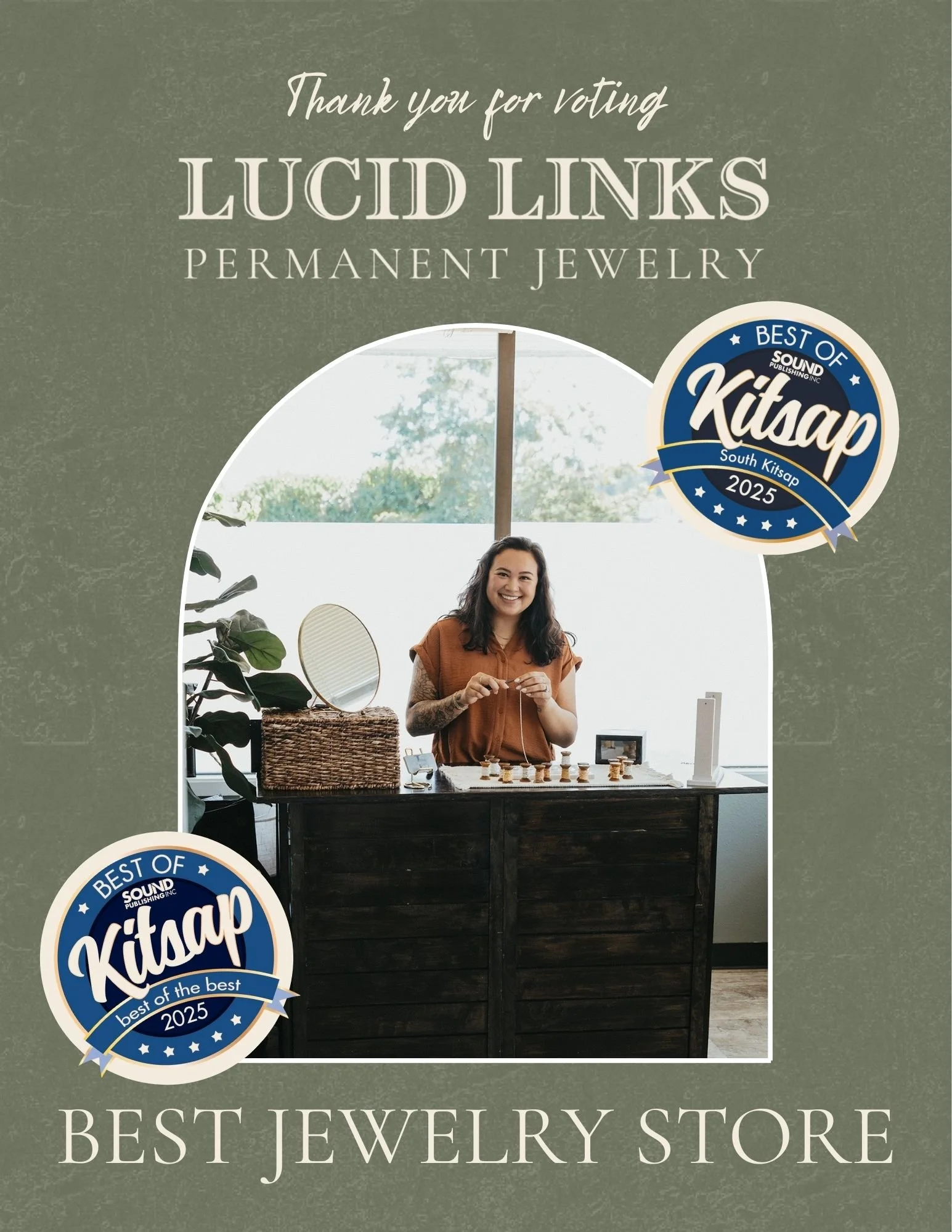 A woman smiling behind a jewelry display at a jewelry store, with posters in the background that read 'Thank you for voting Lucid Links Permanent Jewelry' and 'Best Jewelry Store,' and two badges indicating 'Best of Kitsap 2025.'
