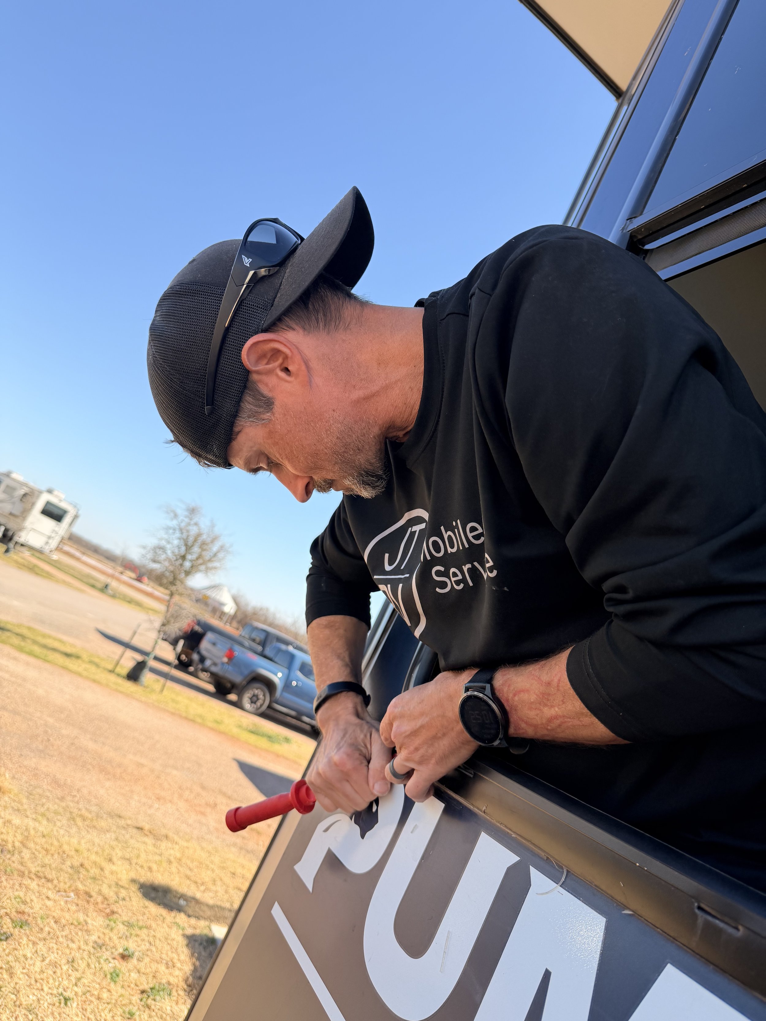 Mobile RV tech removes and replaces broken RV window