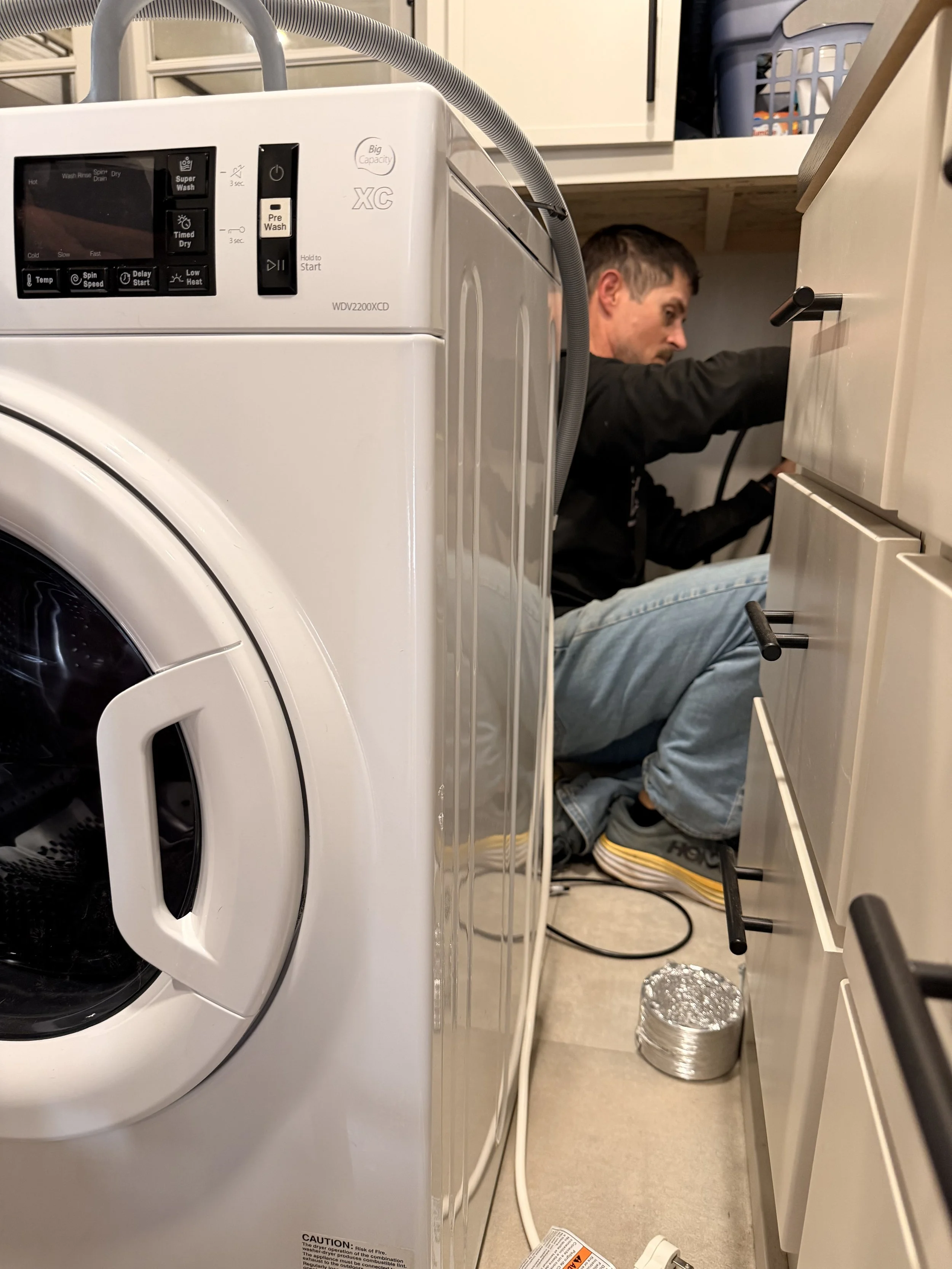 Mobile RV tech installs vent for RV dryer, appliance.