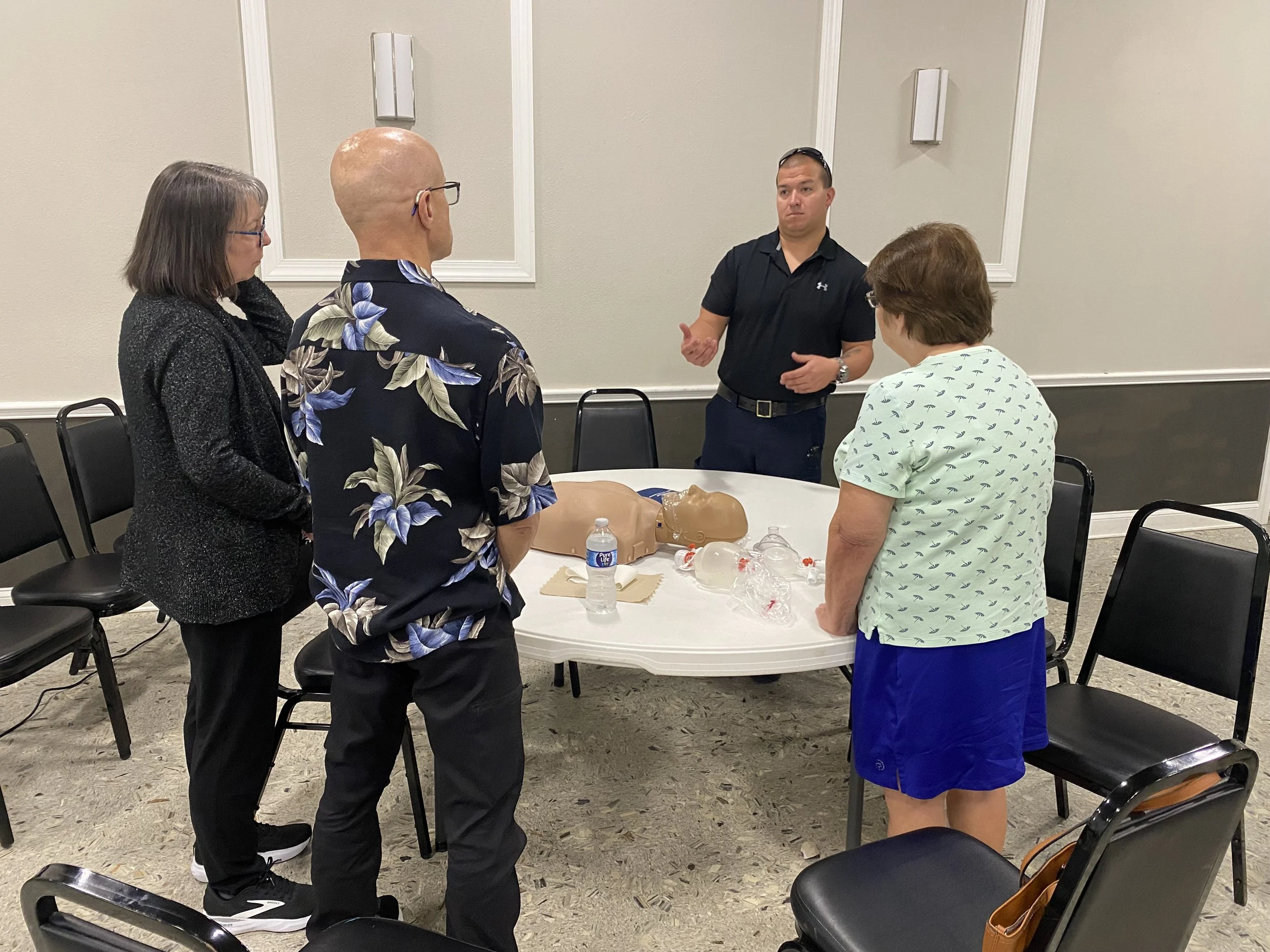 A FACTS first aid instructor leading a hands-on CPR training session for students at the Lakeland Elks Lodge in Florida.