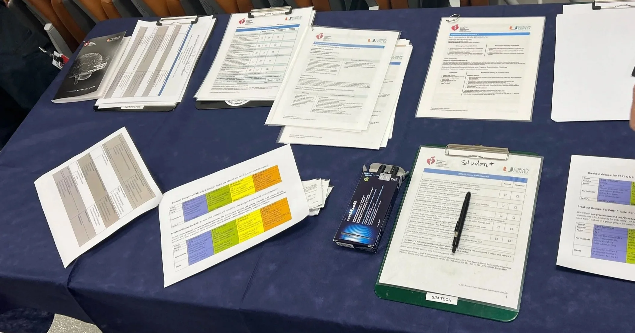 American Heart Association (AHA) training materials, student rosters, and clipboards organized on a table before a FACTS CPR certification class in Lakeland, Florida.