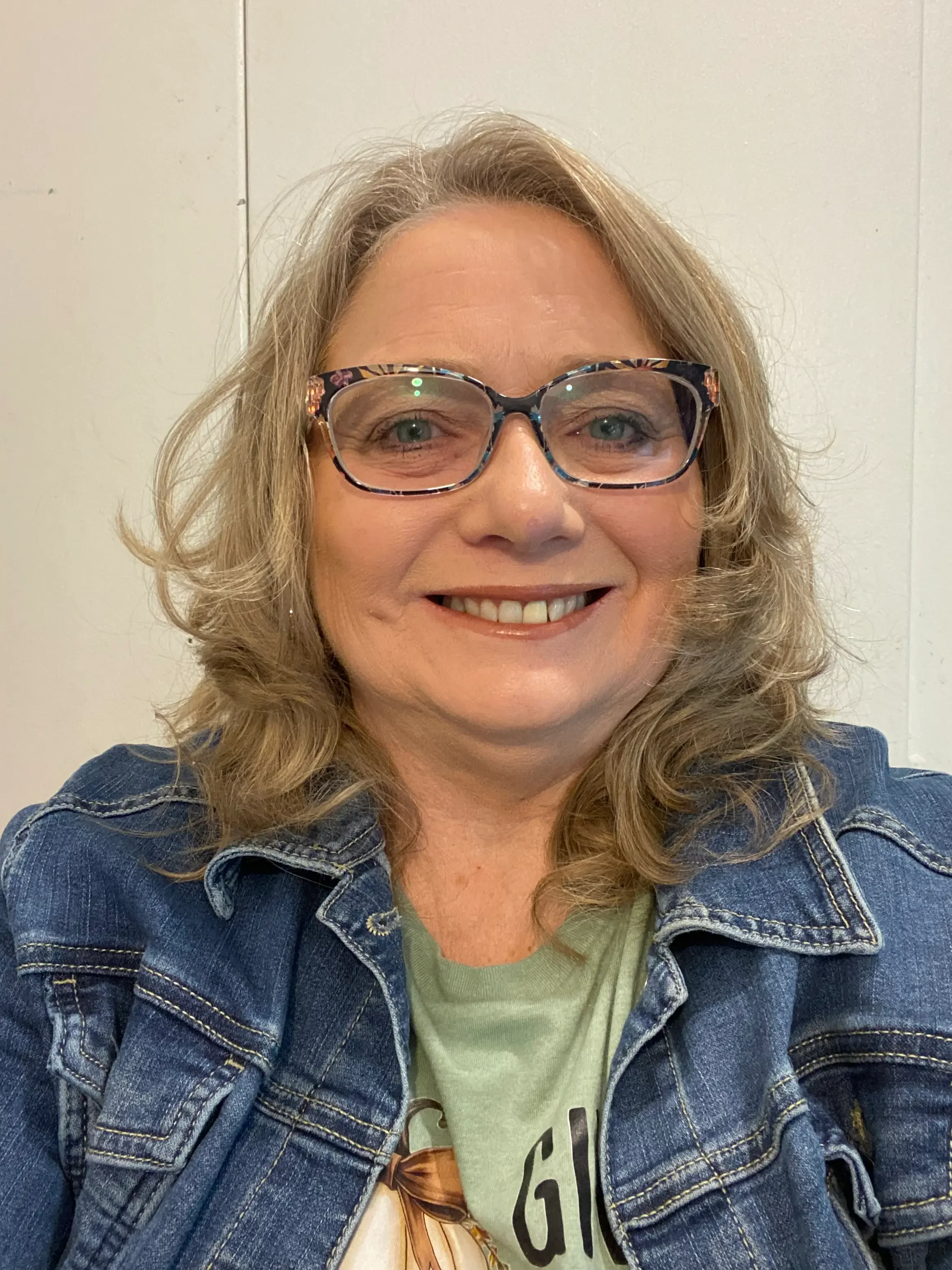 ladyBlondeJeanCoatGlasses.webp