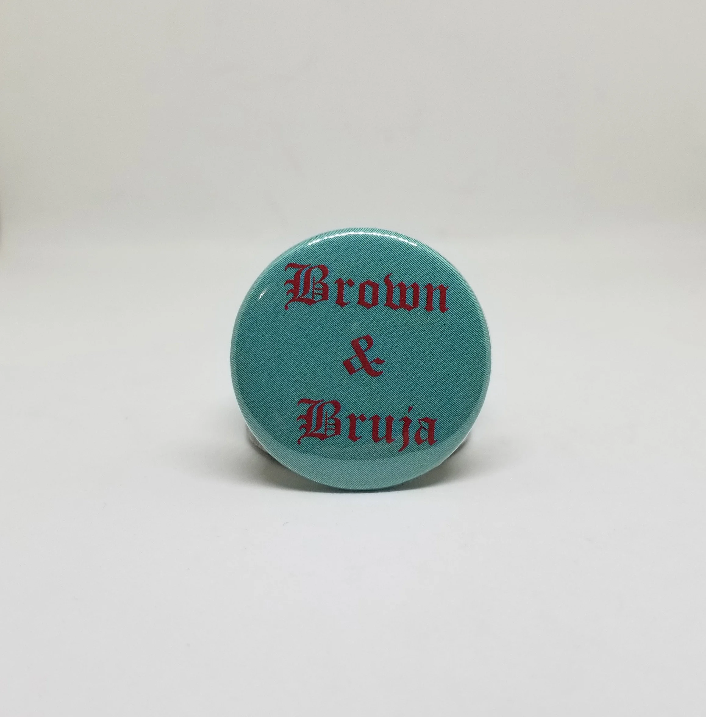 brown and bruja button pin