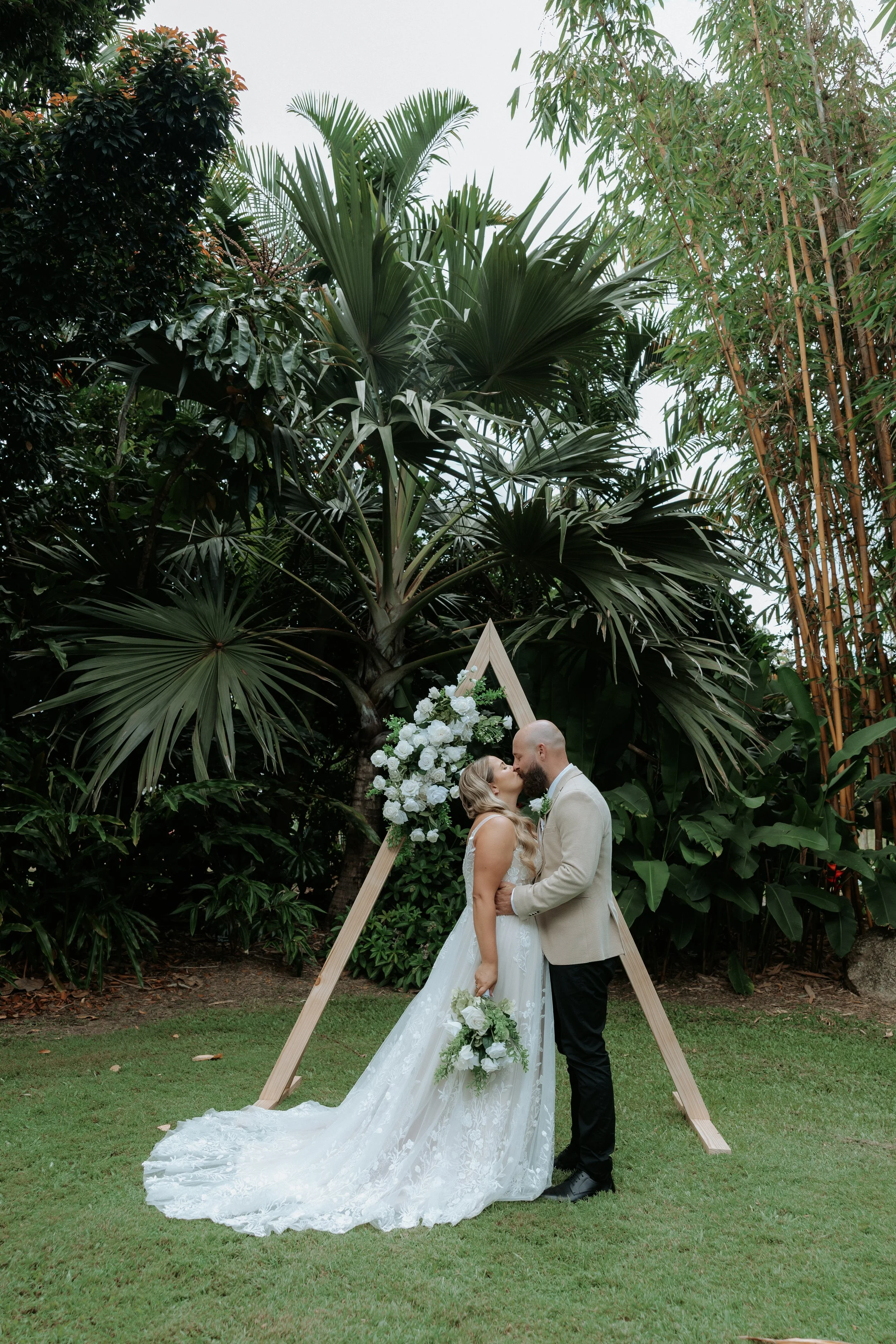 Luxury elopement styling in Hervey Bay featuring floral arbour with green and white flowers for an intimate wedding at Bamboo Land.