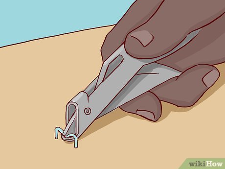 A person using a lancet device to prick their finger for a blood sample.