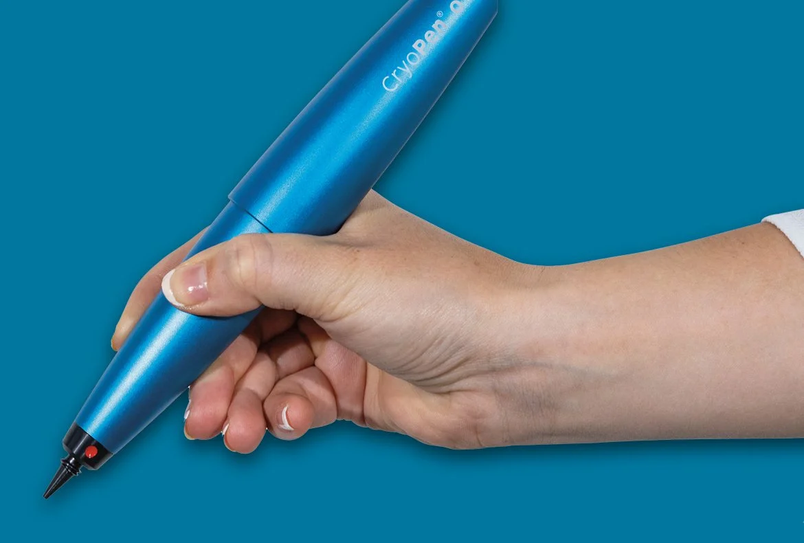 A hand holding a blue 3D printing pen against a blue background.