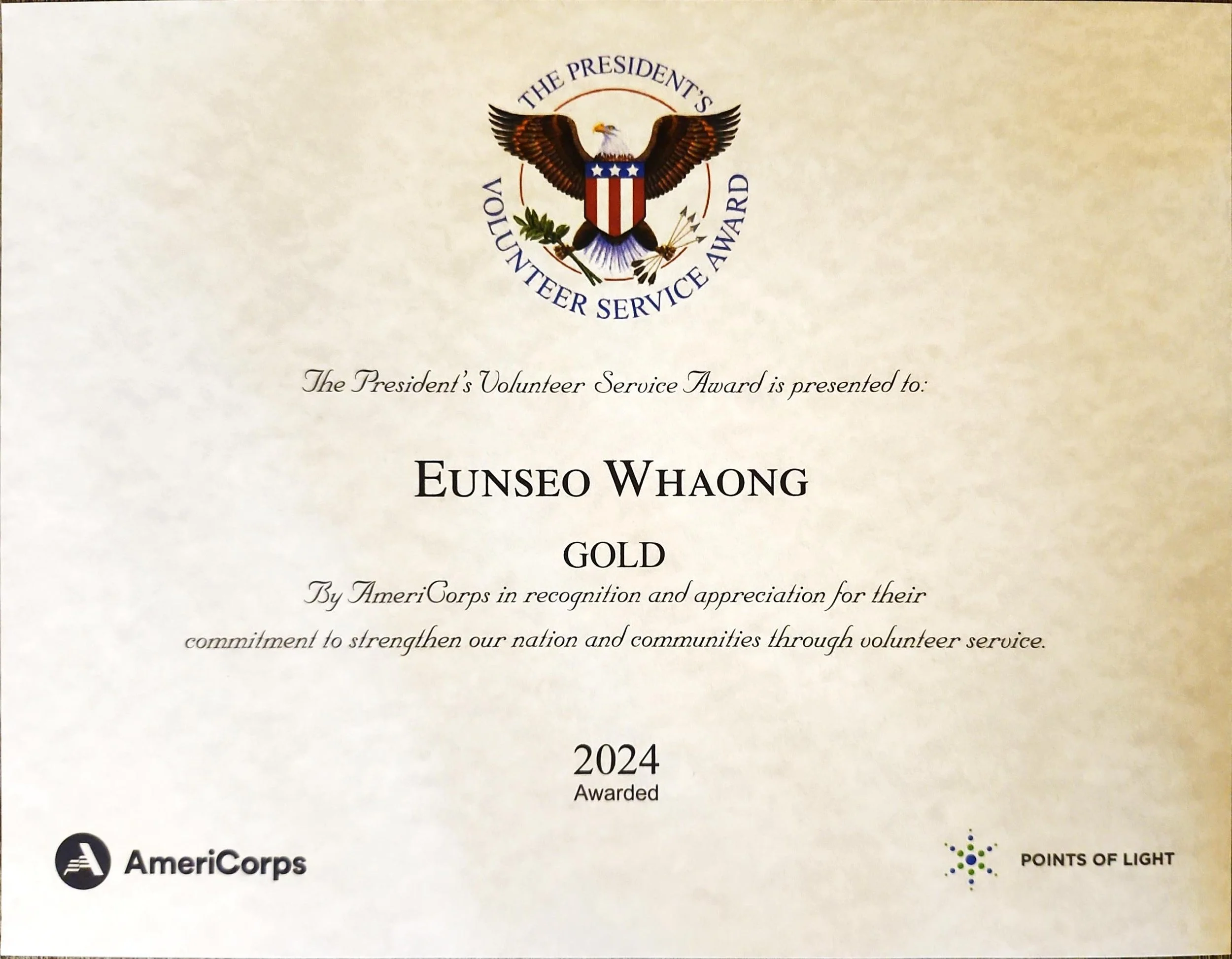 Certificate of the President's Volunteer Service Award presented to Eunseo Whang, awarded in 2024, with logos of AmeriCorps and Points of Light at the bottom and a crest featuring an eagle at the top.