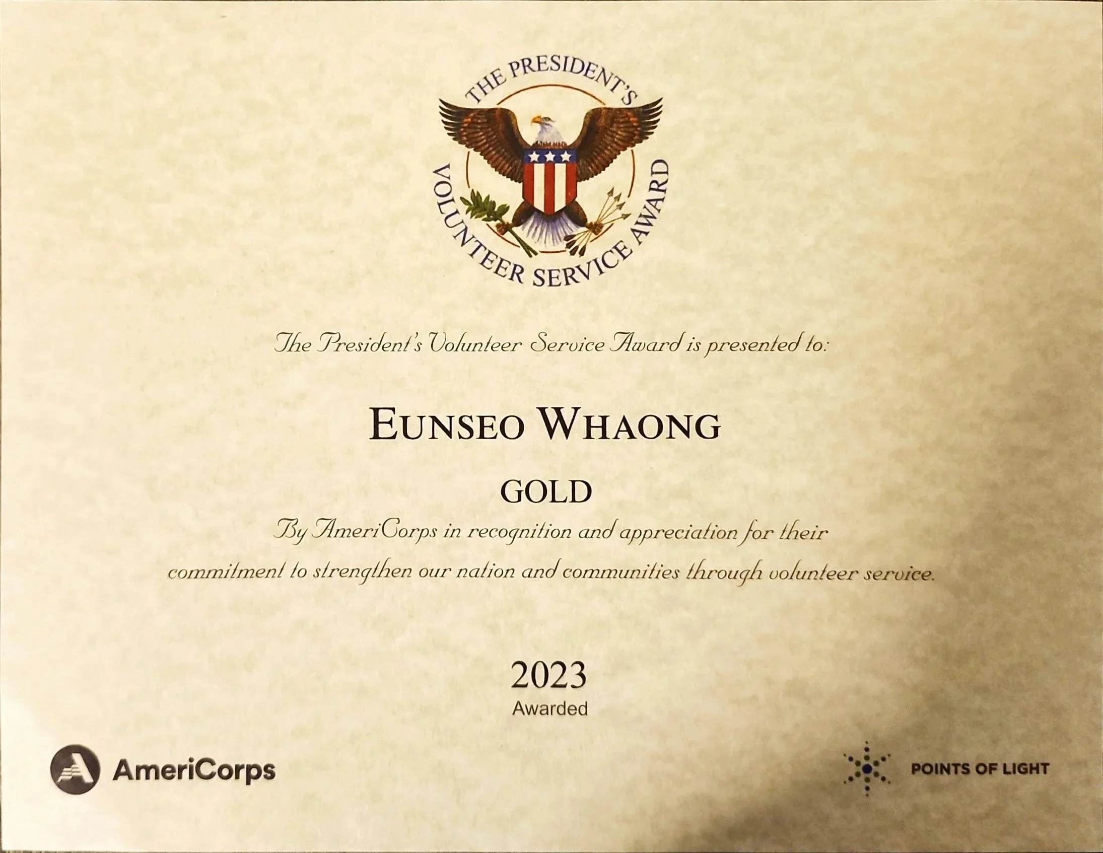 Certificate of the President's Volunteer Service Award for Eunseo Whaong, gold level, awarded in 2023 by AmeriCorps, featuring a crest with an eagle, stars, and shield, and a logo for Points of Light.
