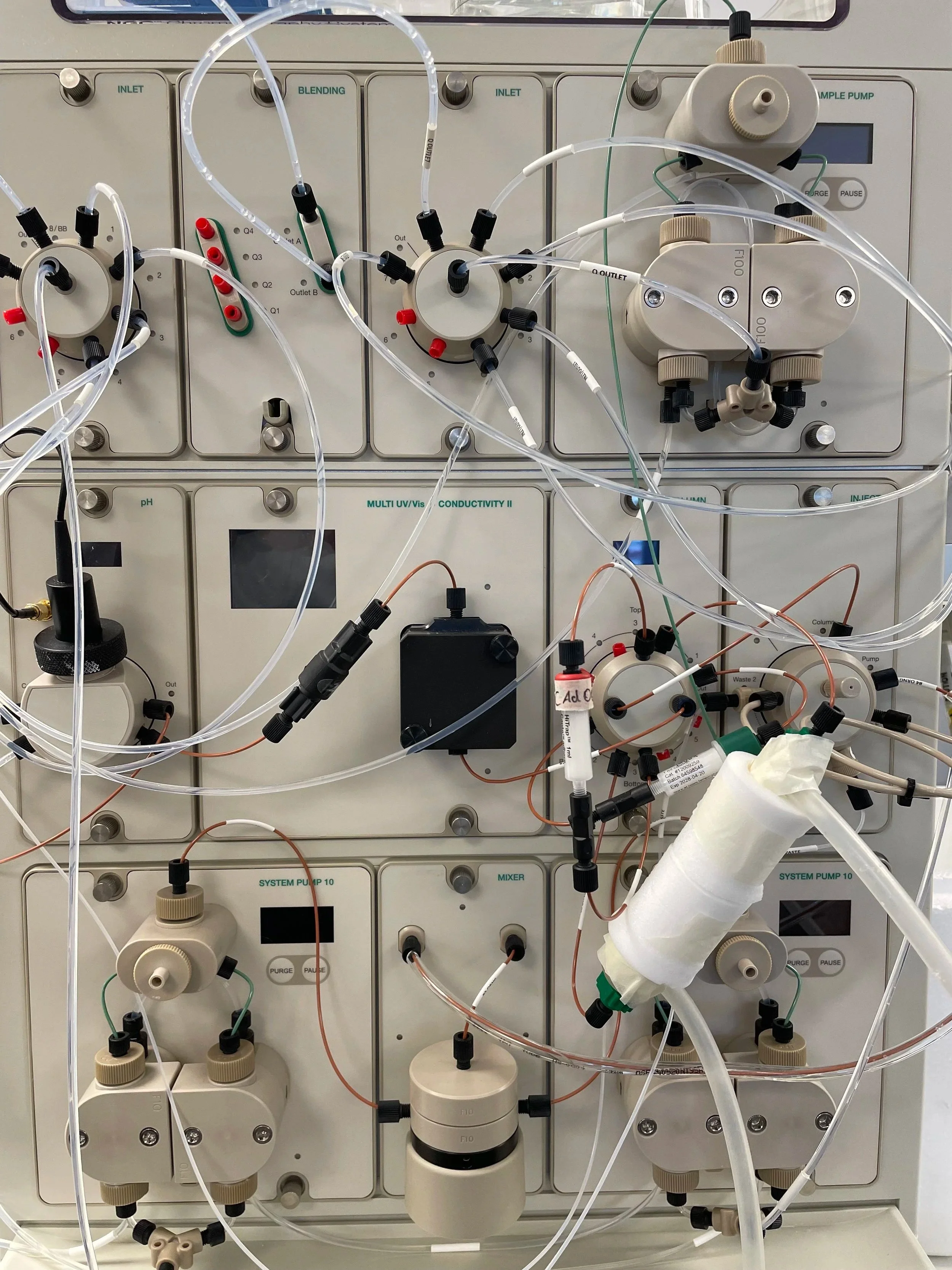Scientific laboratory equipment with tubes, valves, and control panels.