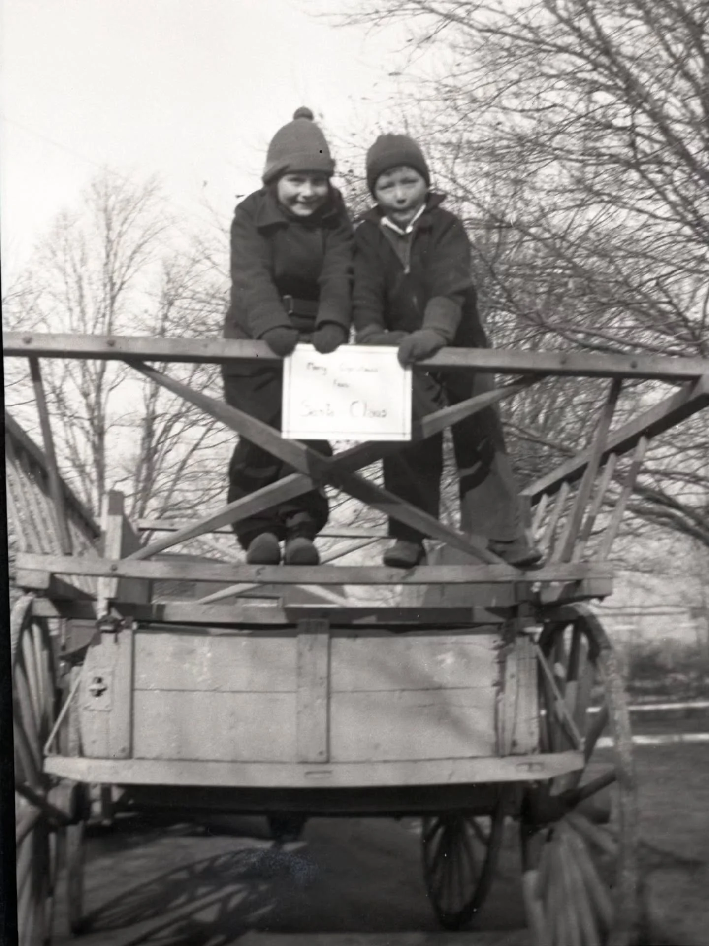 This festive photo was taken on December 24, 1936. Anne and Gordon Price are standing on the back of an Ingaldsby hay wagon holding up a sign, "Merry Christmas from Santa Claus."

This photograph comes from the Ingalls-Price photograph coll