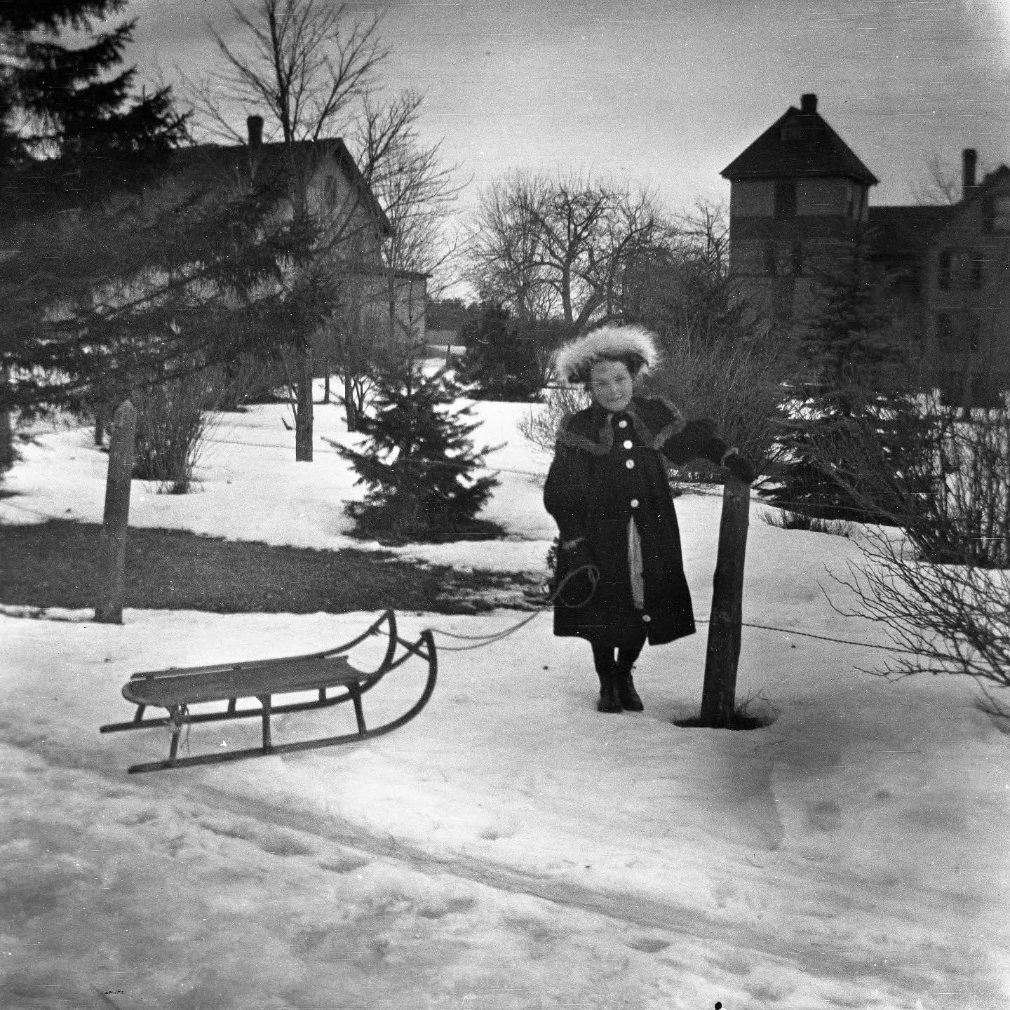 This little girl was headed out for a day of sledding on Main Street in West Boxford around 1900. The house in the background is 553 Main Street, which is still there, but no longer has the turreted addition shown here.

The photograph comes from the