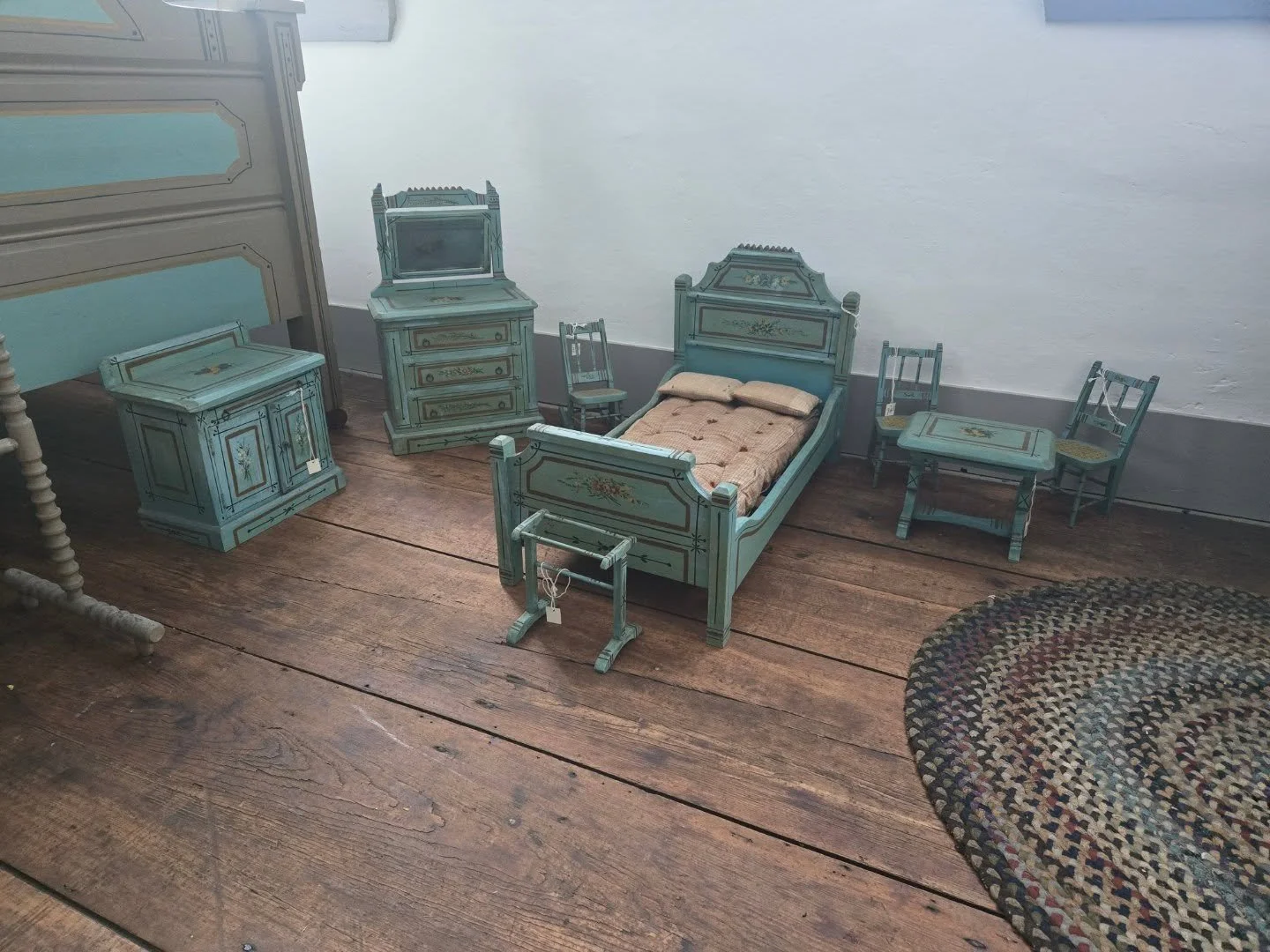 This set of doll furniture was made for Gertrude French when she was a young child to match her bedroom set. It may have been crafted by her neighbor, Samuel Ayer, who was a carpenter and made many toys for her. Her father then painted it to match th