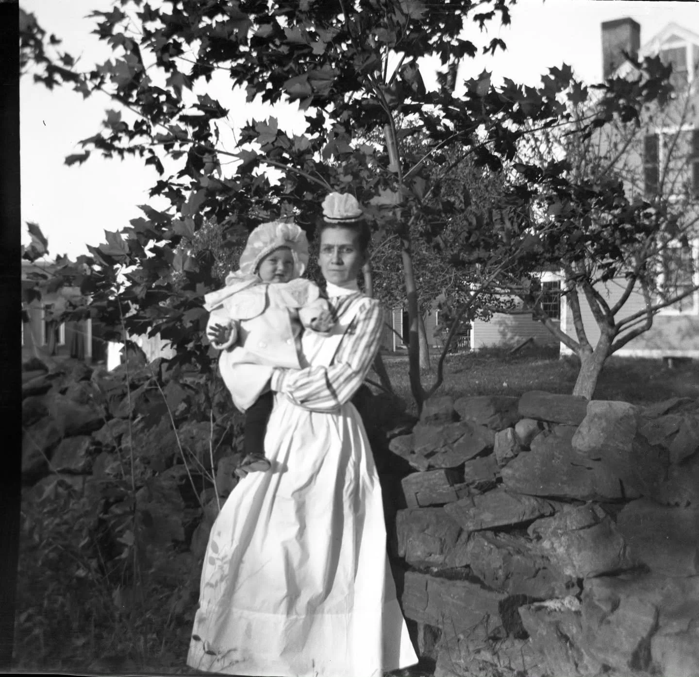 Baby and nursemaid standing in what is now the Benson's parking lot, with 177 Washington Street visible in the background. This photograph is unmarked, but it may show baby Carl Robinson, c.1905. It is part of the Mary A. (Spofford) Robinson Collecti
