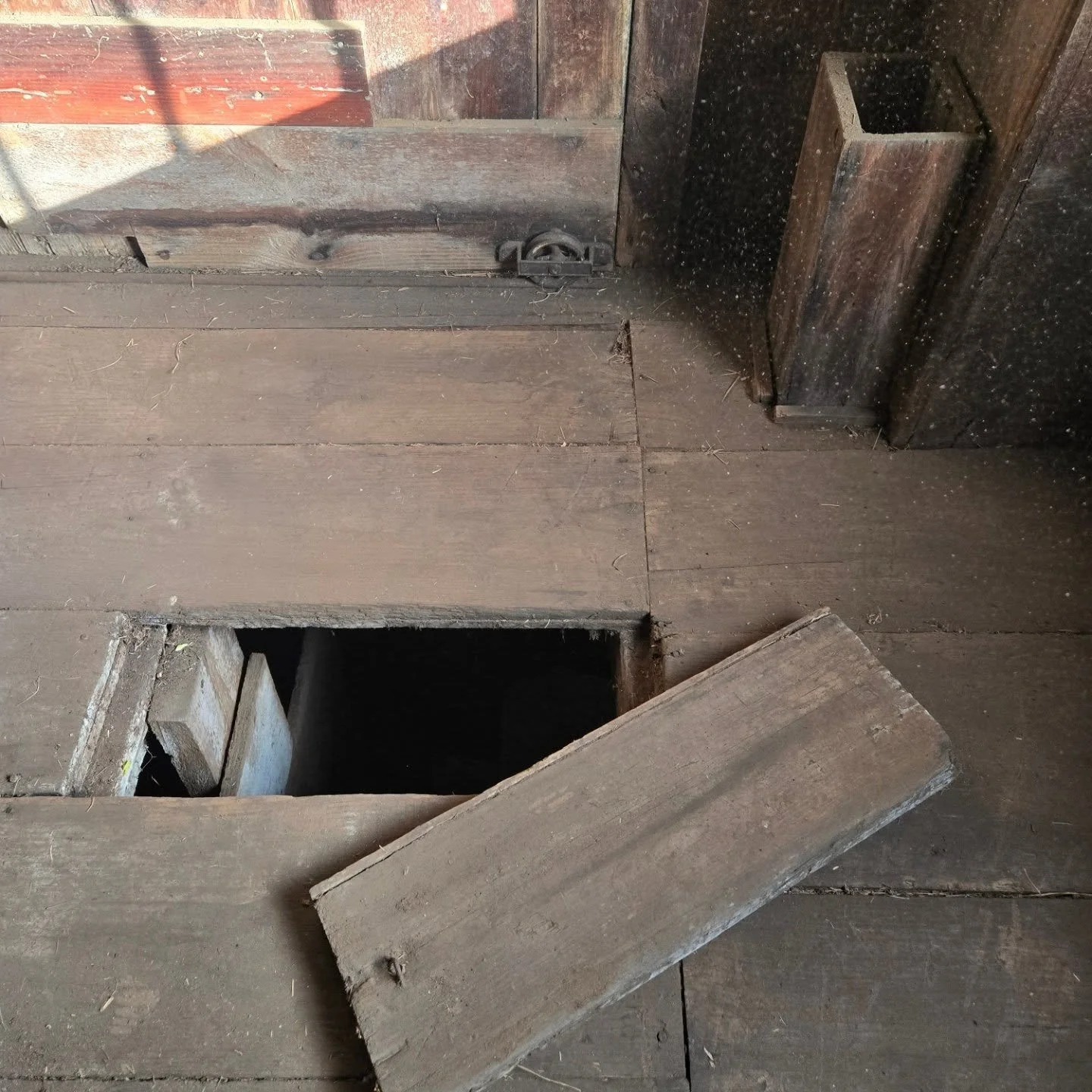 The barn at the Holyoke-French house was built by the French family in 1867. This little trapdoor in the floor of the main level of the barn is right above the horse stalls in the basement. It was probably used to fork down fresh hay for bedding, and