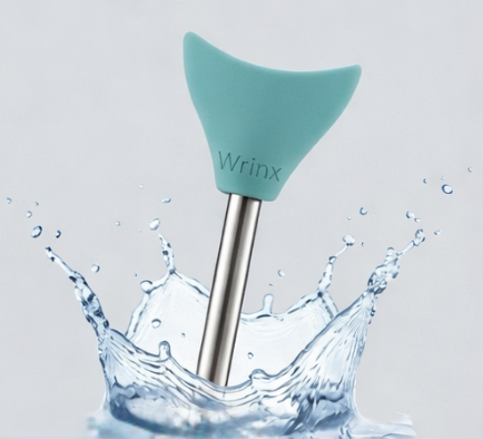 stainless steel straw with wrinx straw attachment in a splashing cup of water
