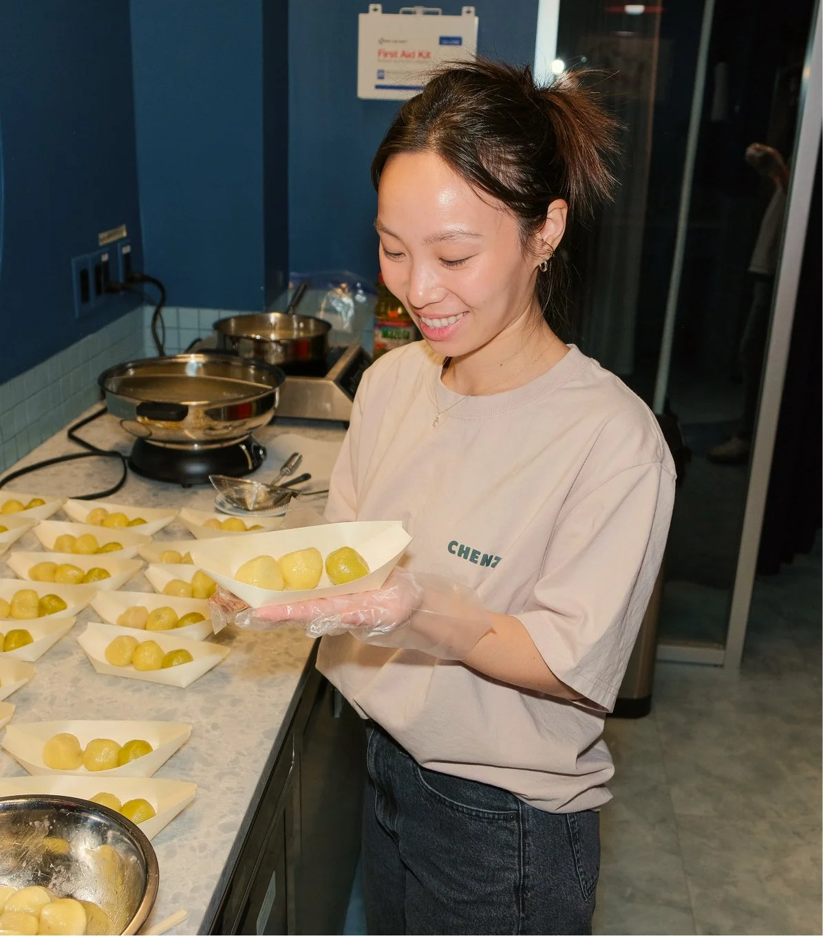 Christina, founder of Chenzi, holding Chenzi Fuzhounese potato balls at an event to serve to customers.