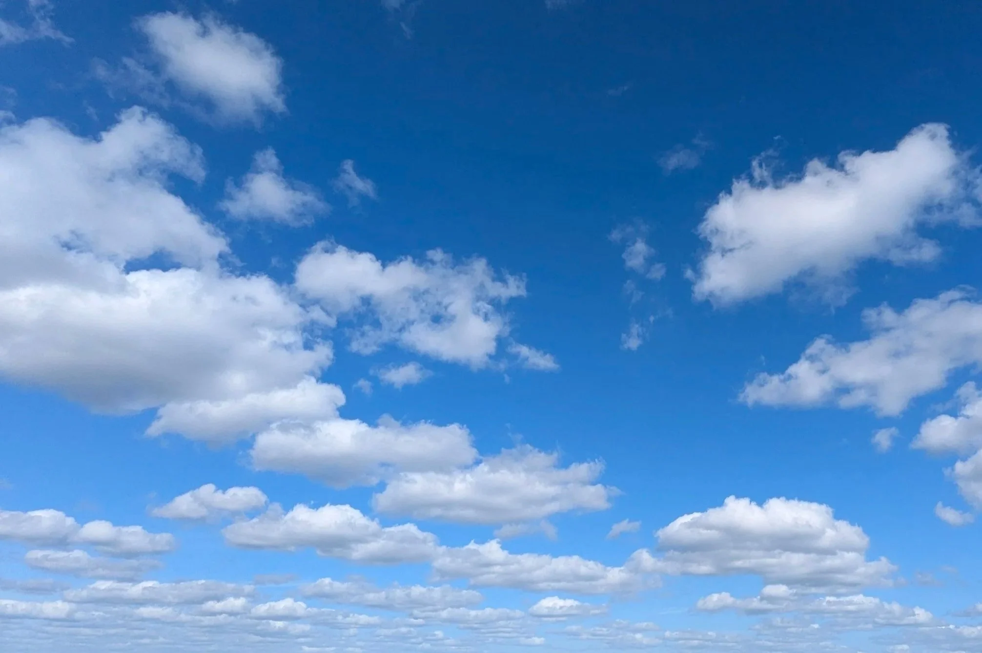 Blue sky filled with scattered white clouds