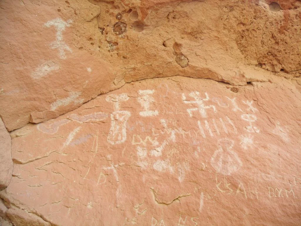 A pictograph panel also with graffiti.