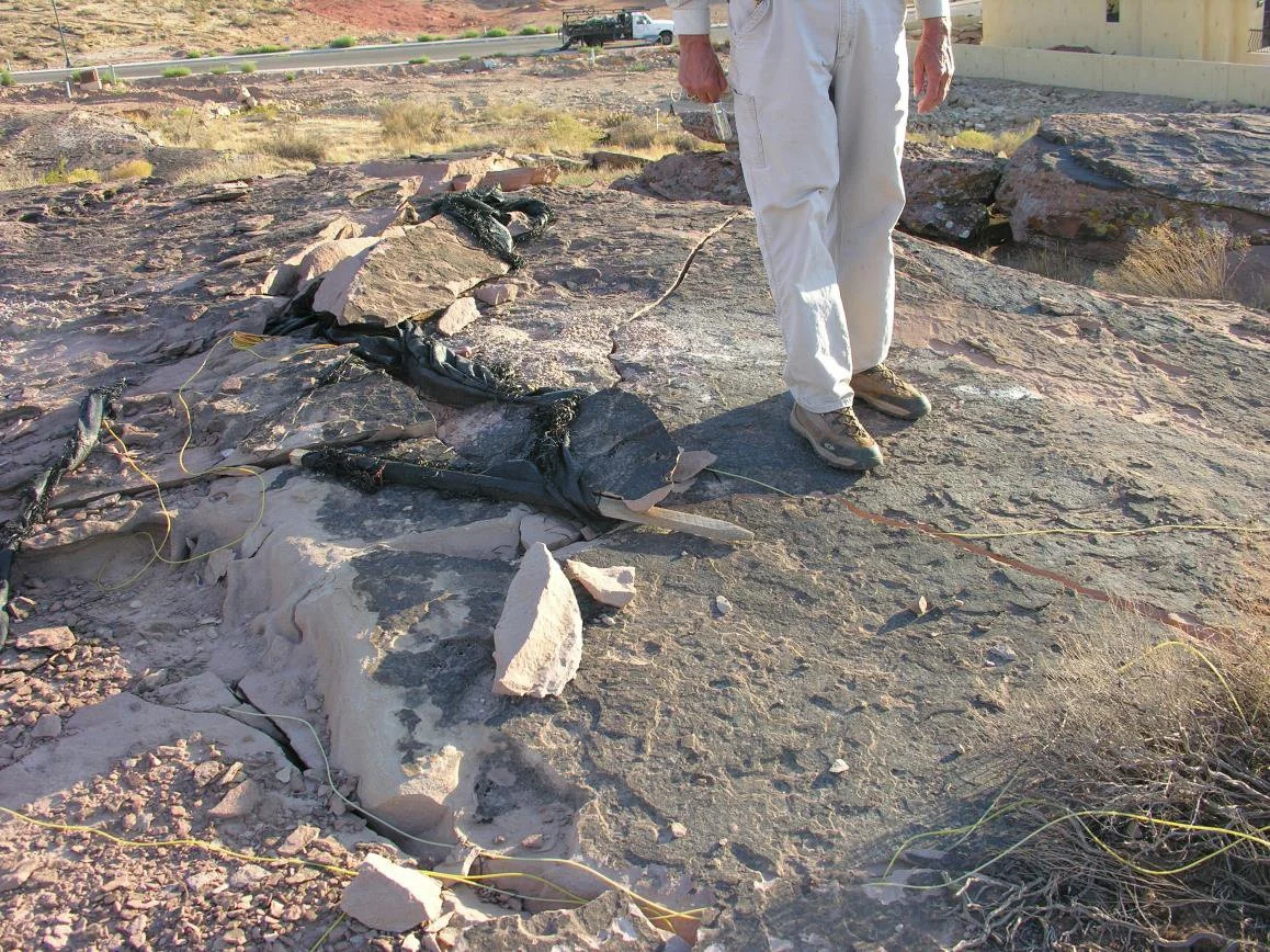 This is an example of horizontal petroglyphs being blasted to make room for houses.
