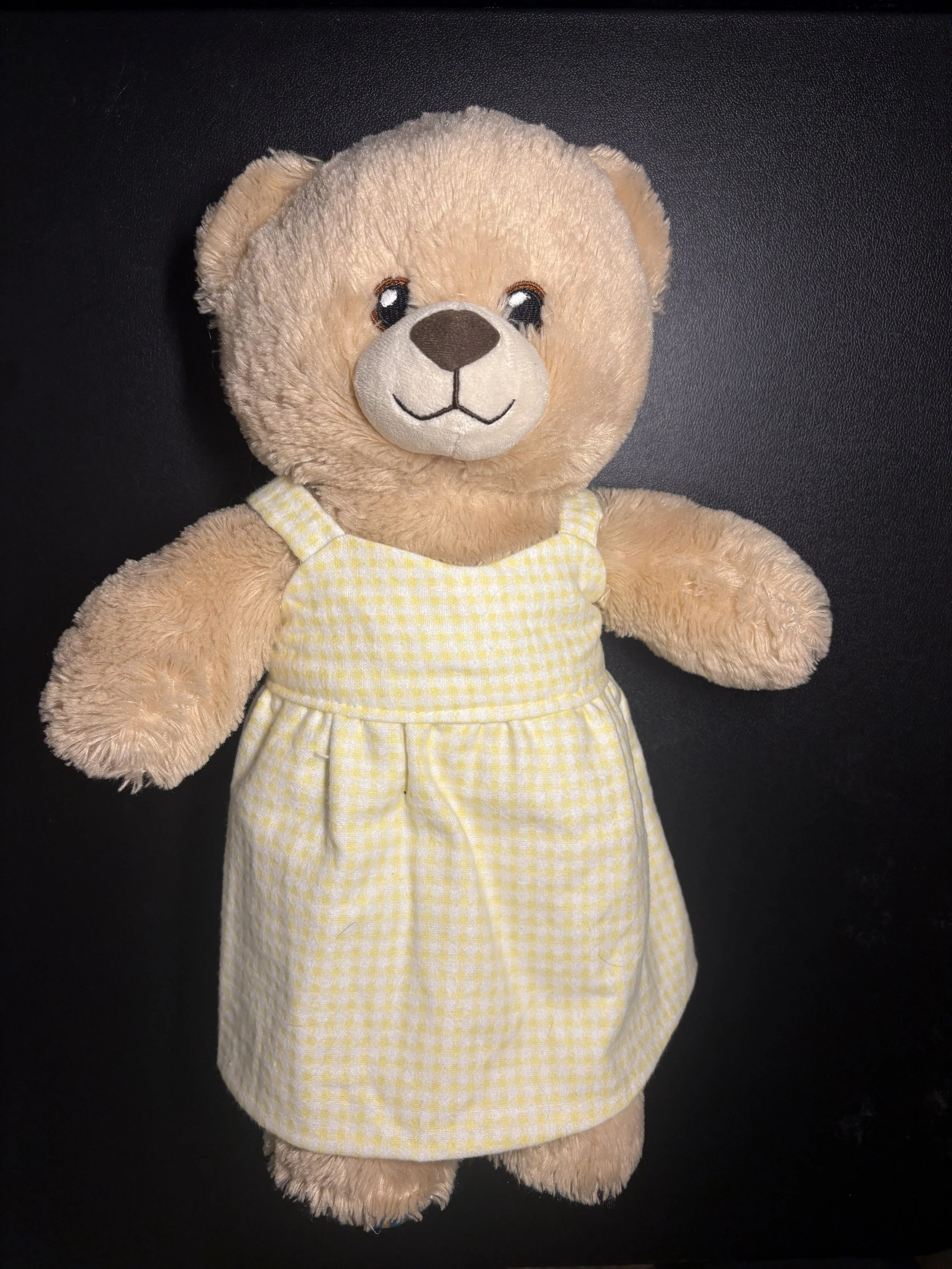 Teddy Bear wearing the Yellow Gingham dress handmade by Sew Far, So Good.