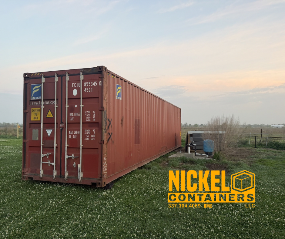 A red shipping container placed on a grassy field with a partly cloudy sky in the background. To the right of the container, there is a small air conditioning unit or generator. The bottom right corner features the logo and contact information for Ni
