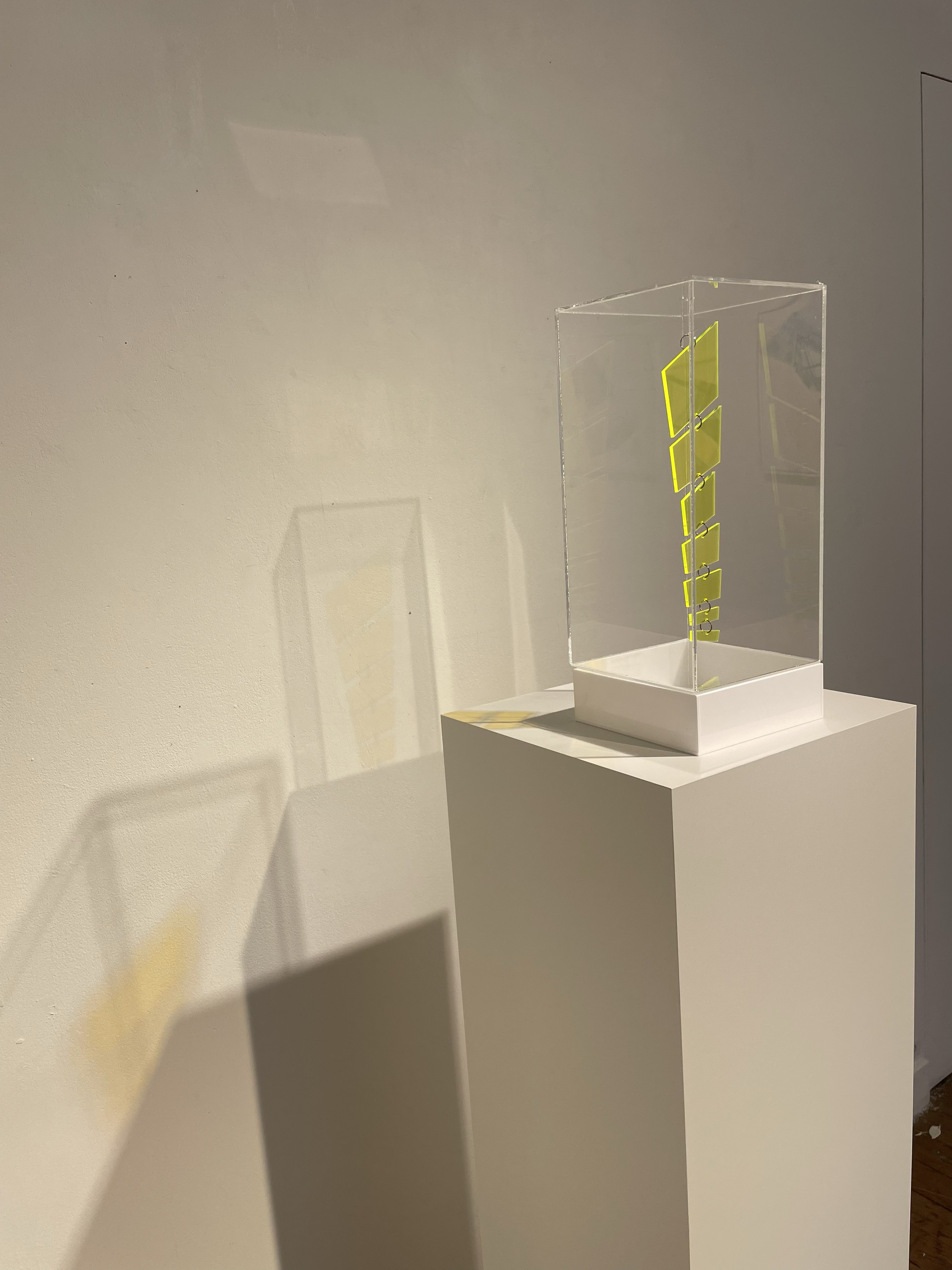 Maquette no 6. Prototype for suspended installation. 
Laser cut yellow perspex held within LED perspex box (15cm x 15cm x 35cm).
2025