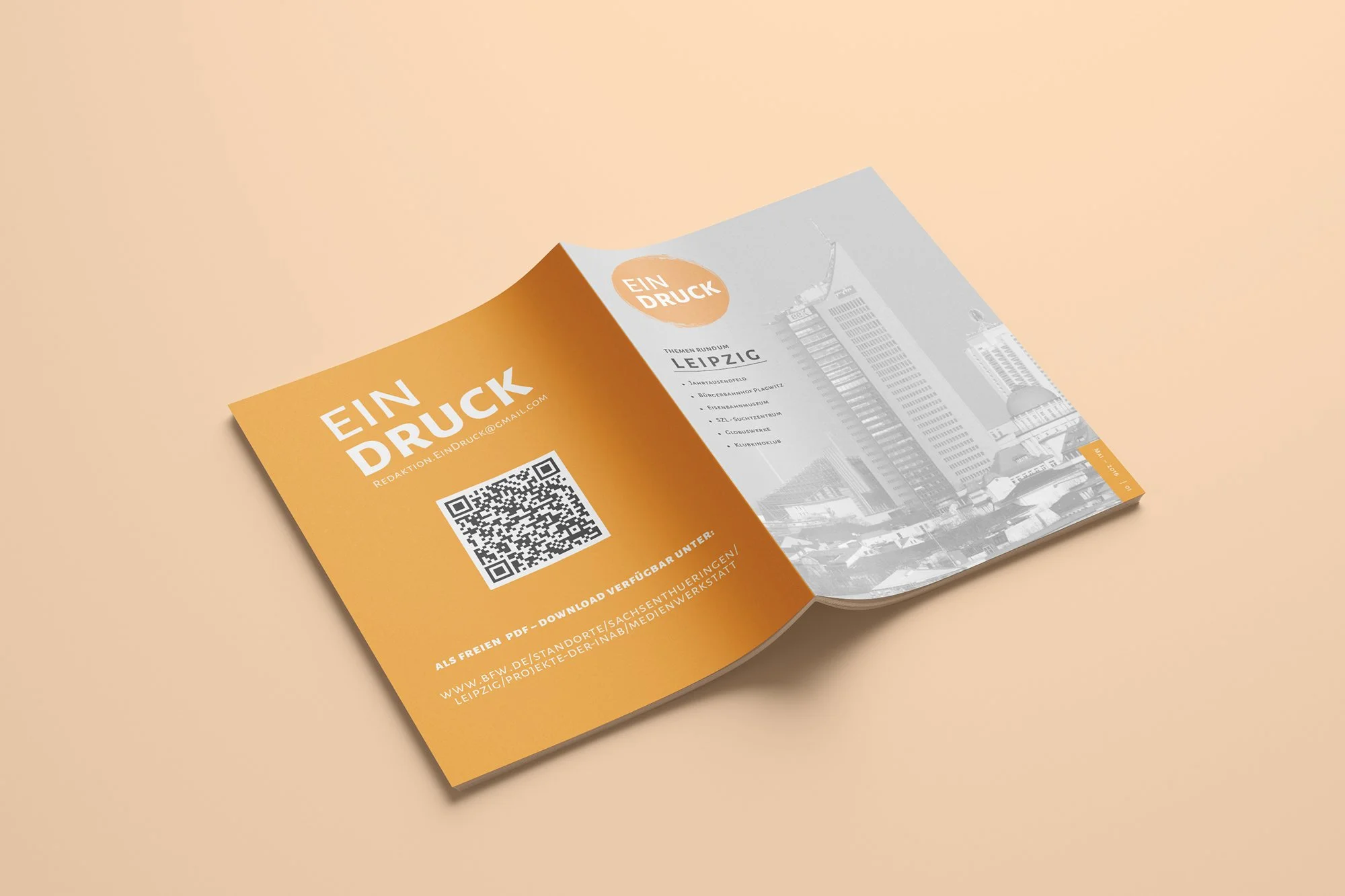 Open orange and gray brochure with QR code and cityscape of Leipzig, Germany, on the right page, and the title 'EIN DRUCK' on the left page.