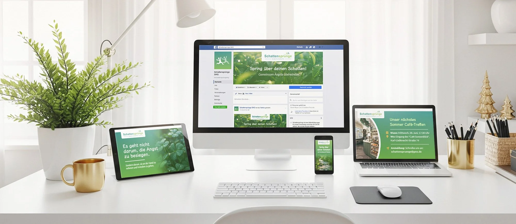 A white office desk illuminated by natural light from a window, with a large leafy green plant in a white pot, a white keyboard, a white mouse on a gray mouse pad, three electronic devices displaying green-themed promotional content, and a gold cup. In the background, gold decorative trees and a pen holder with black pens are visible.