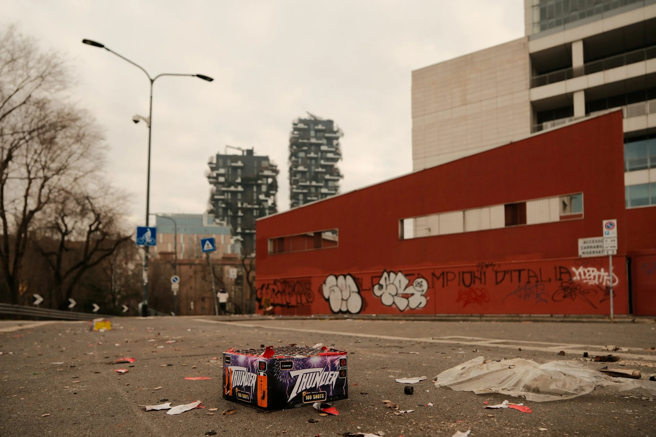 A neglected parking lot covered in trash and debris.