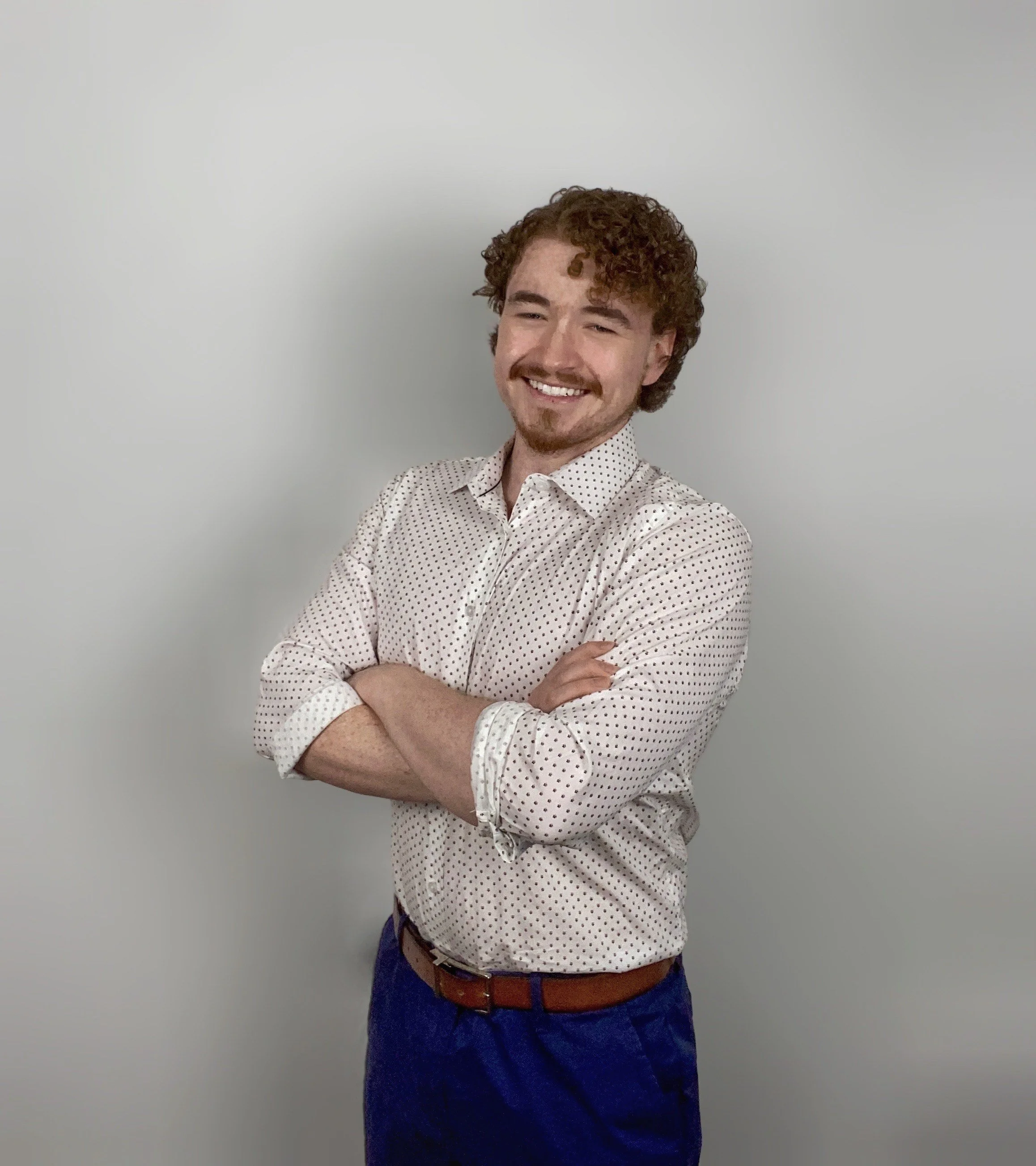 Anthony Pelletier smiling with arms crossed