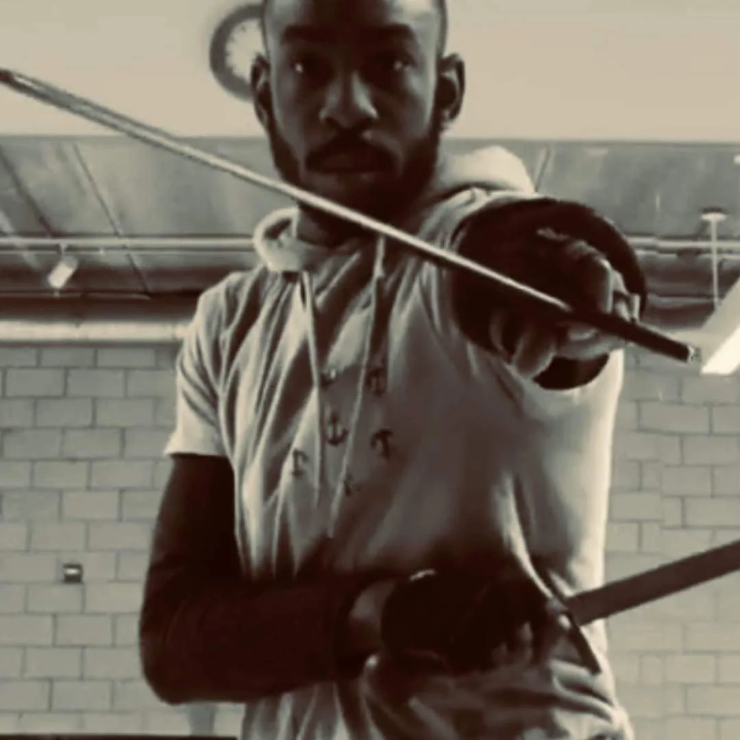 Coach Ardarius "AD" posing with a sword