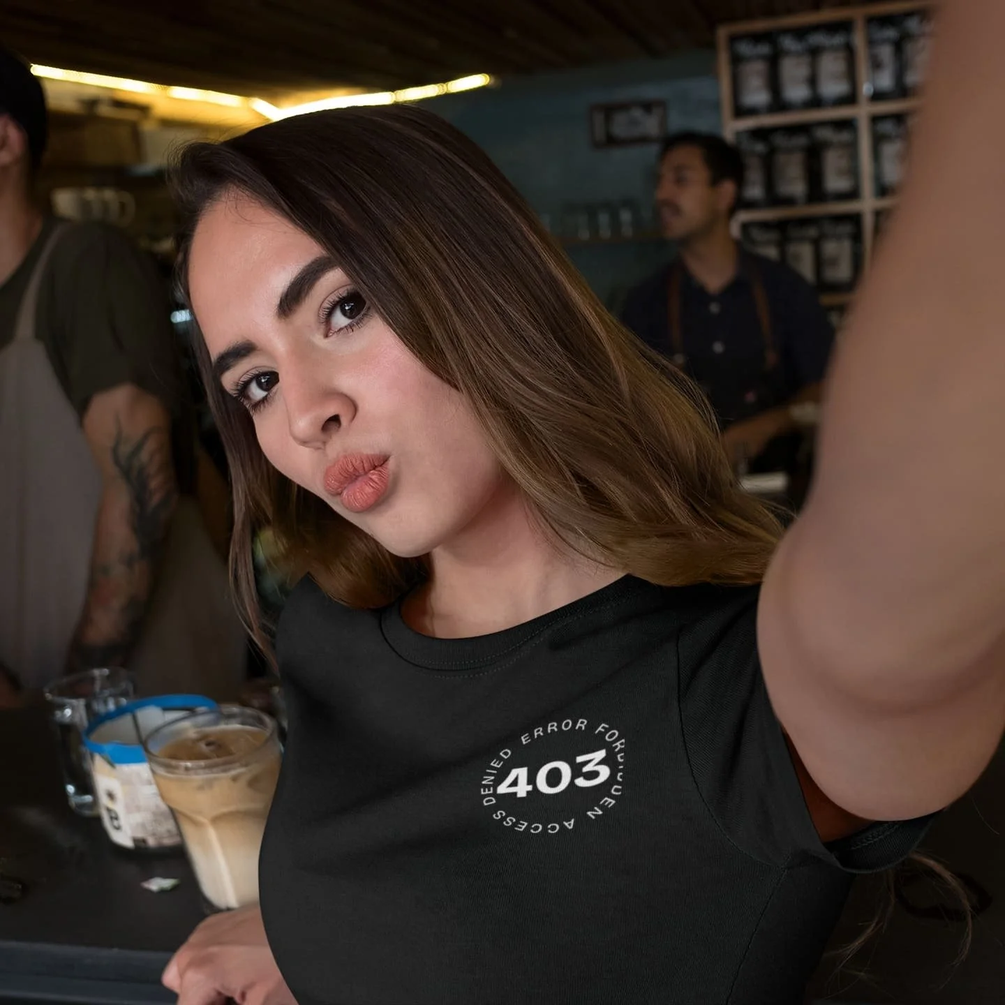 woman-taking-a-selfie-while-at-a-coffee-counter-bar-wearing-a-tshirt-a17049 (3).jpg