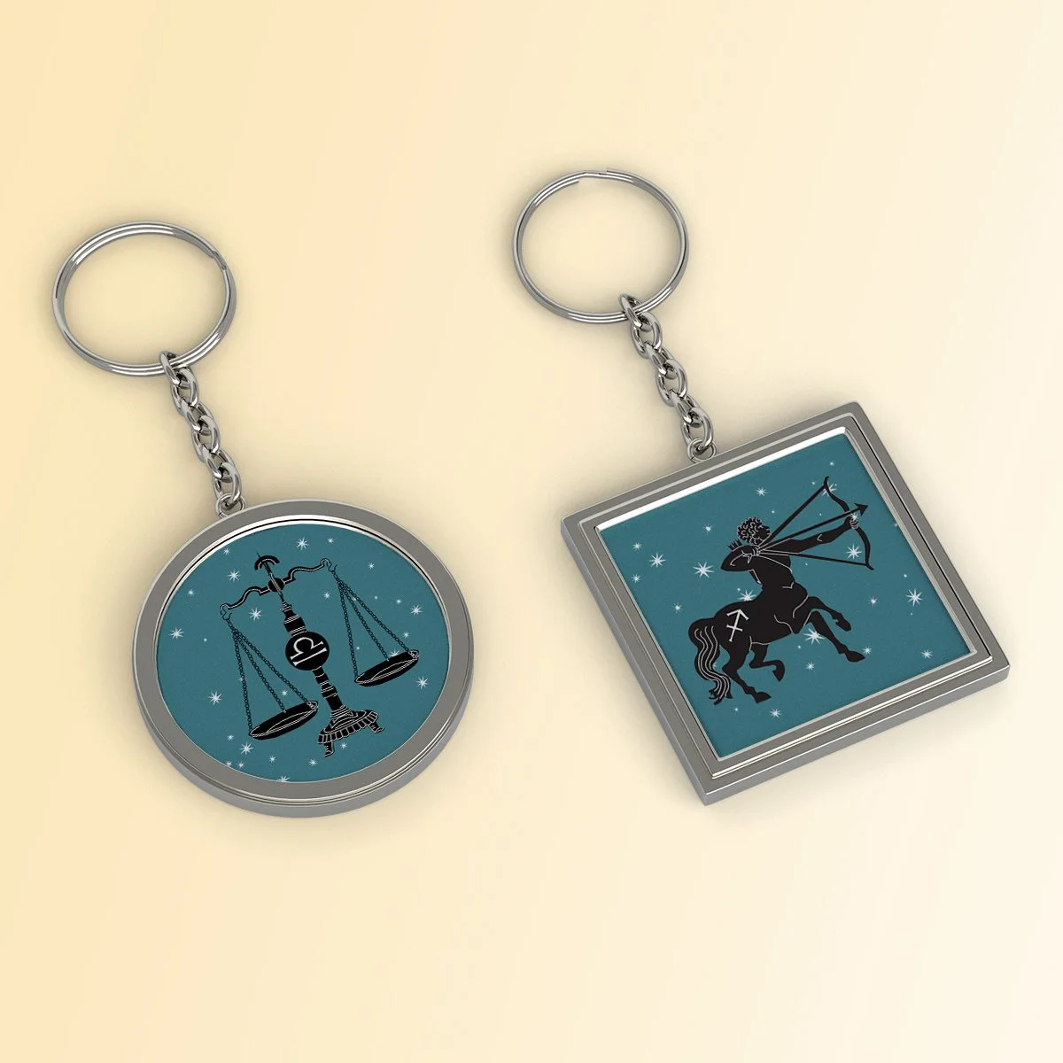 Libra & Sagittarius astrology symbol keychain pendants, illustrated by Terry Marks