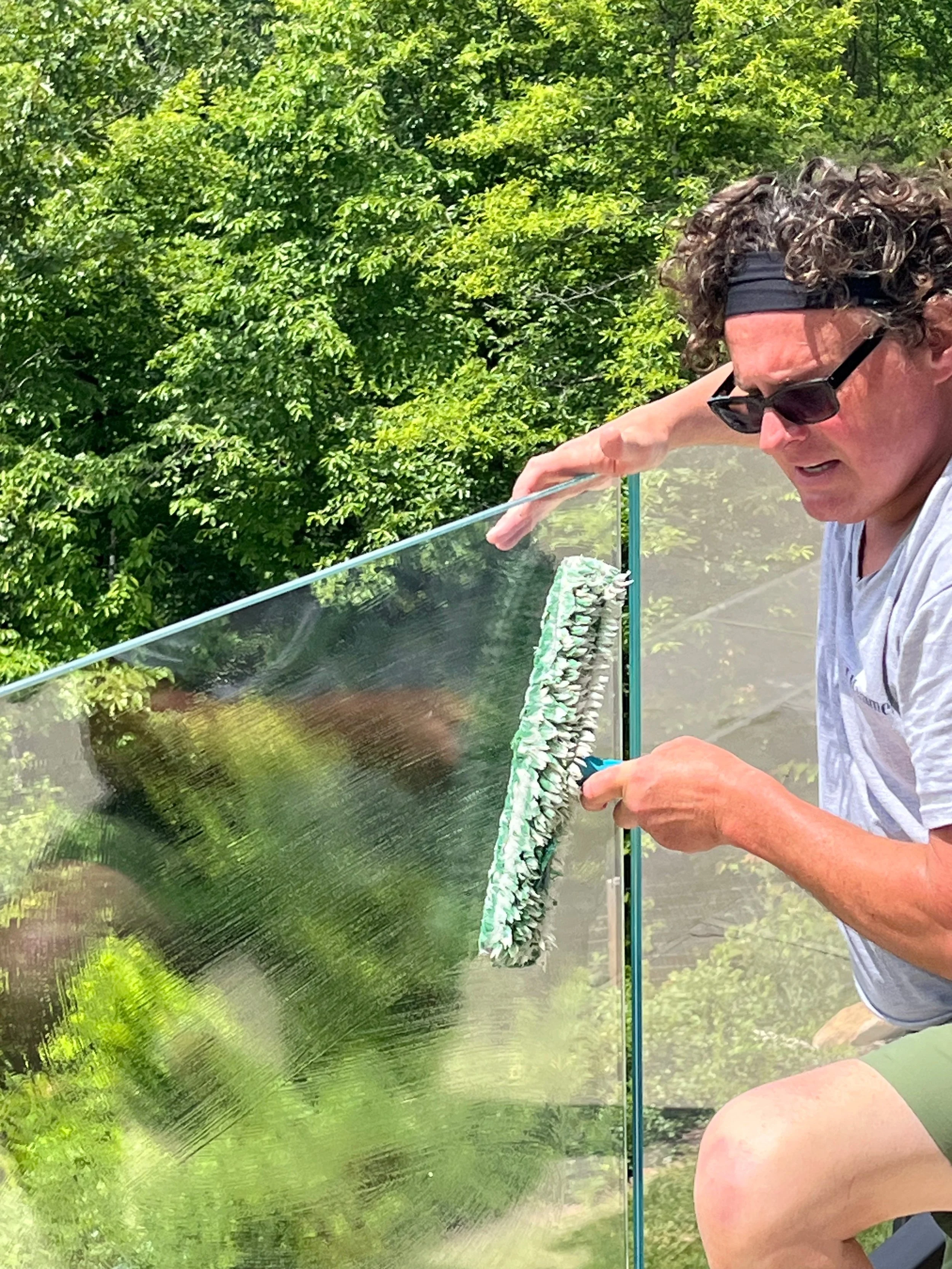 Hammer Window Washing owner cleaning exterior windows.