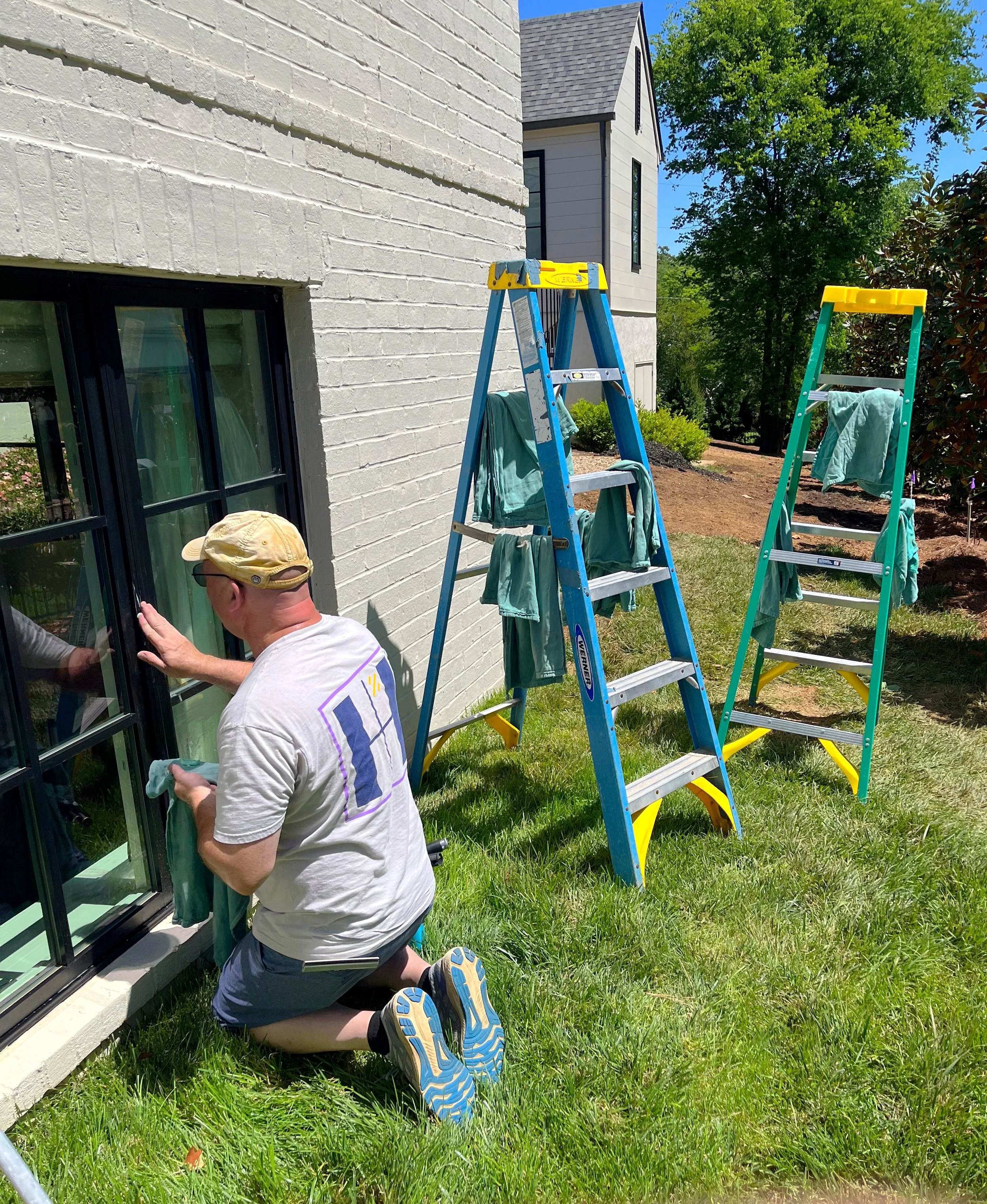 Hammer Window Washing employee cleaning a window.