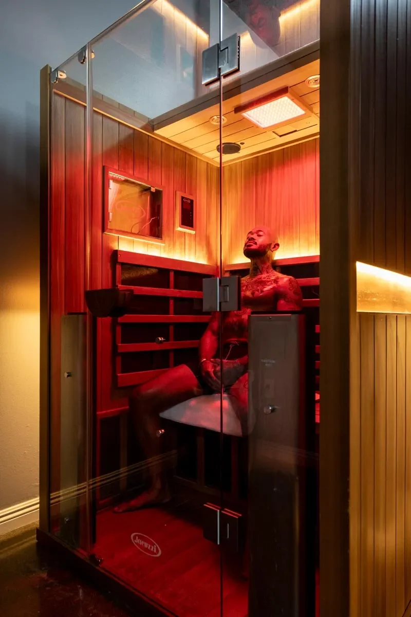 Guest relaxing in an infrared sauna at Float Seattle