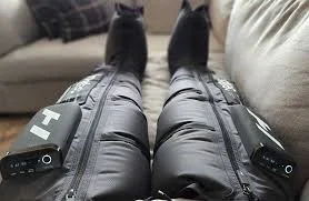 Normatec compression boots on a guest's legs