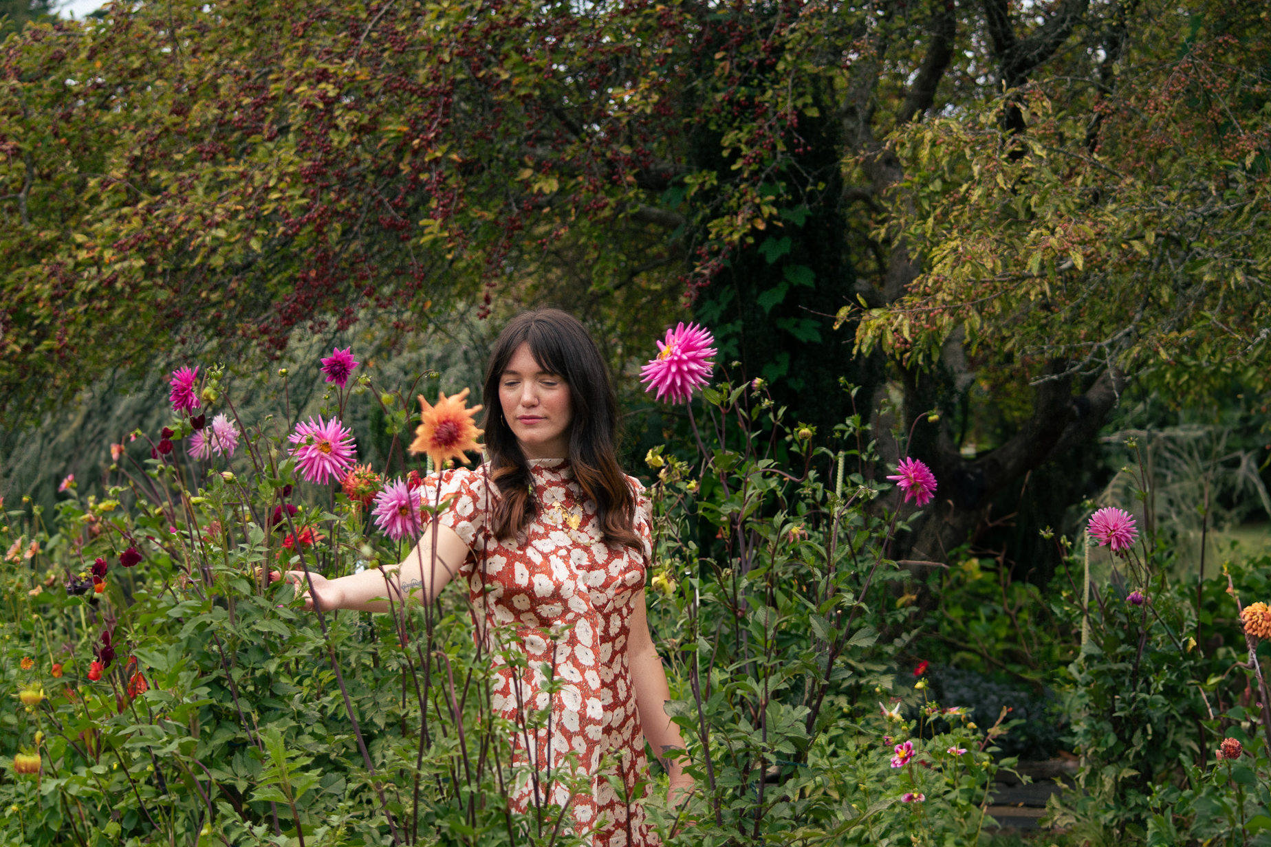 Therapist smiling looking at flowers in a natural environment